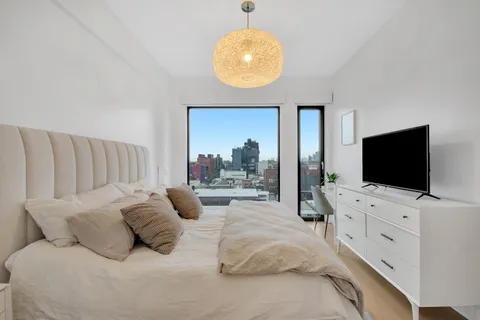 a hotel room with large bed and a flat screen tv