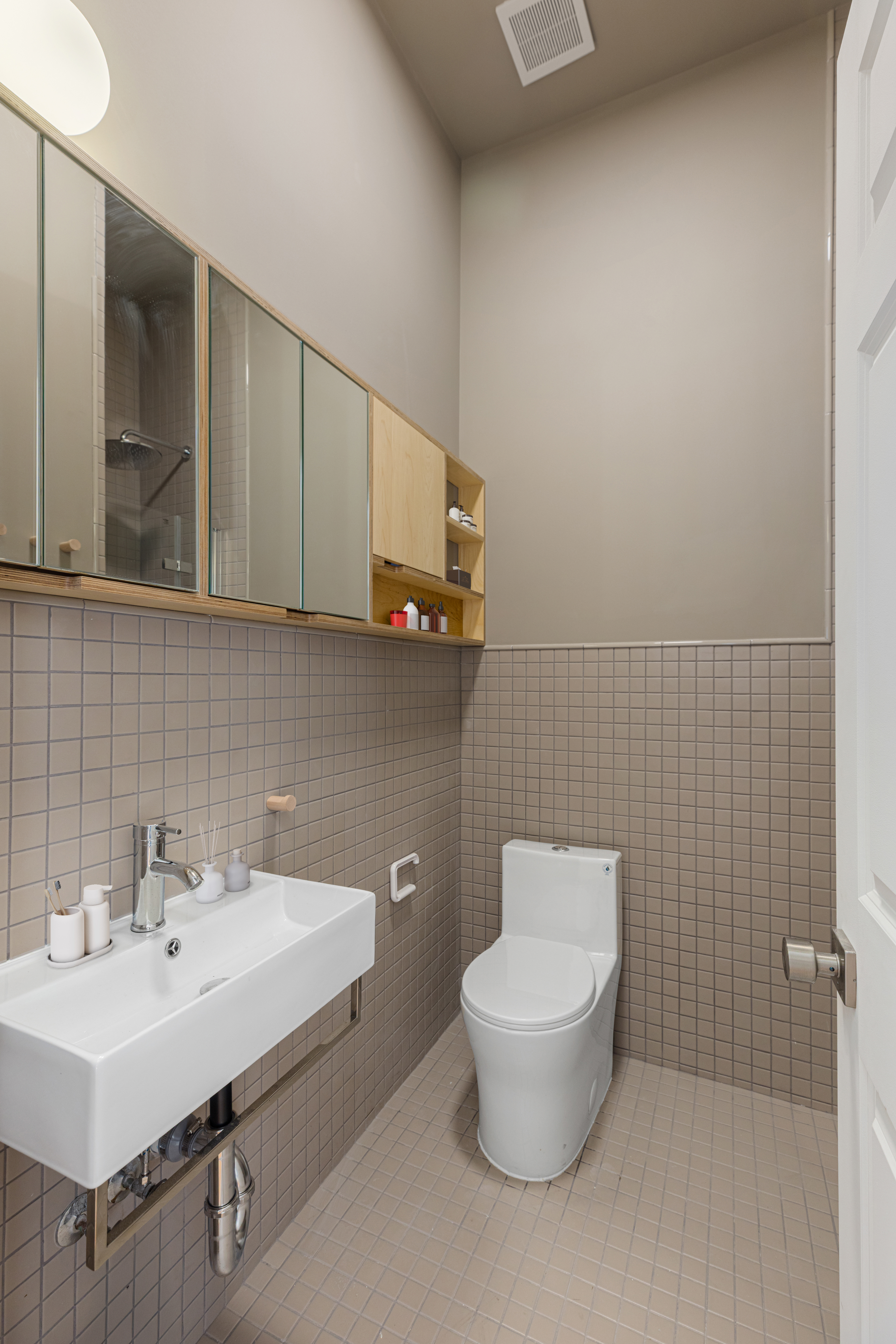 1068 Hancock Street, Unit 1 Brooklyn, NY 11221 - Photo 10 of 11 a bathroom with a sink a toilet and mirror