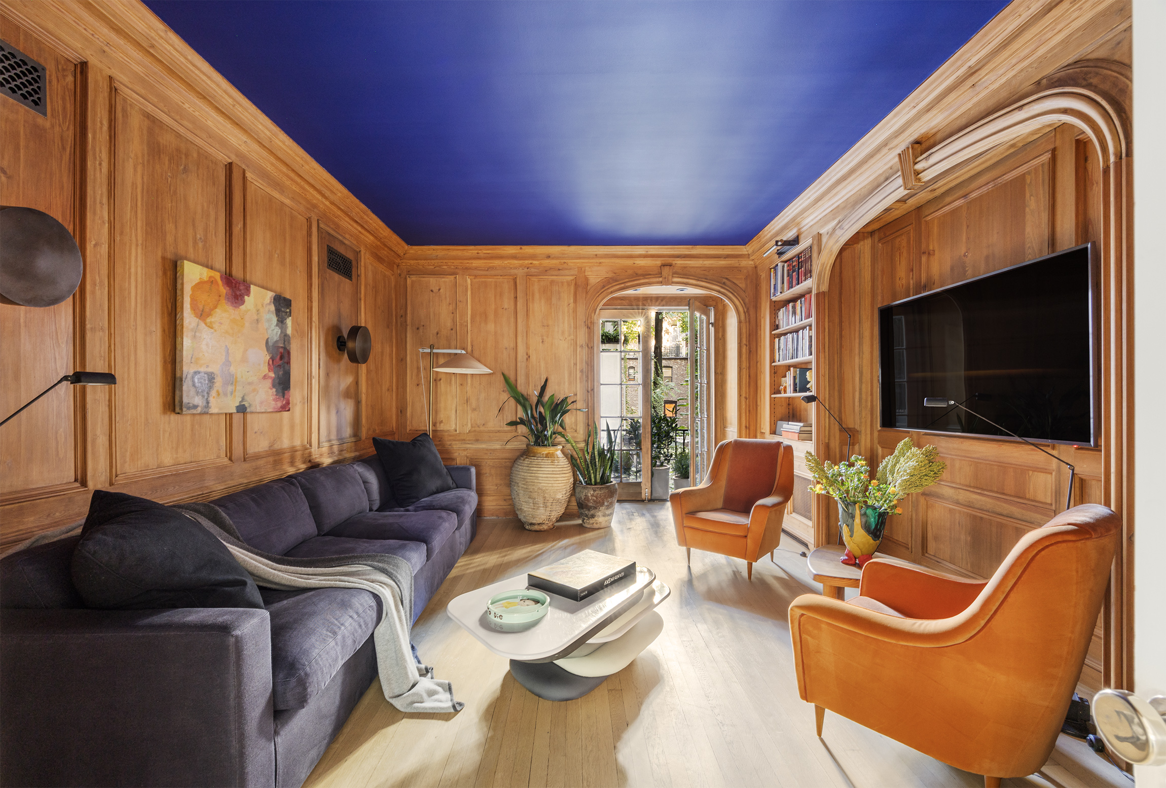 133 East 64th Street, Unit 2B Manhattan, NY 10065 - Photo 5 of 14 a living room with furniture fireplace and flat screen tv