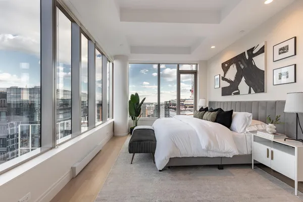 a bedroom with a bed and a large window