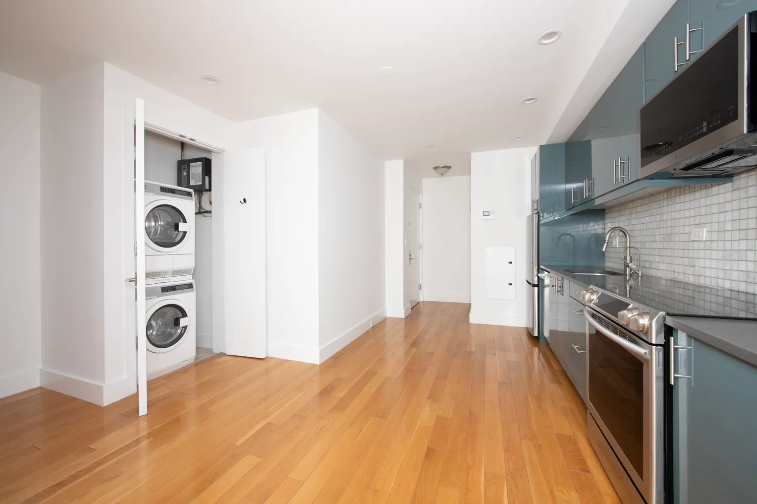 a kitchen with stainless steel appliances granite countertop a stove and a refrigerator
