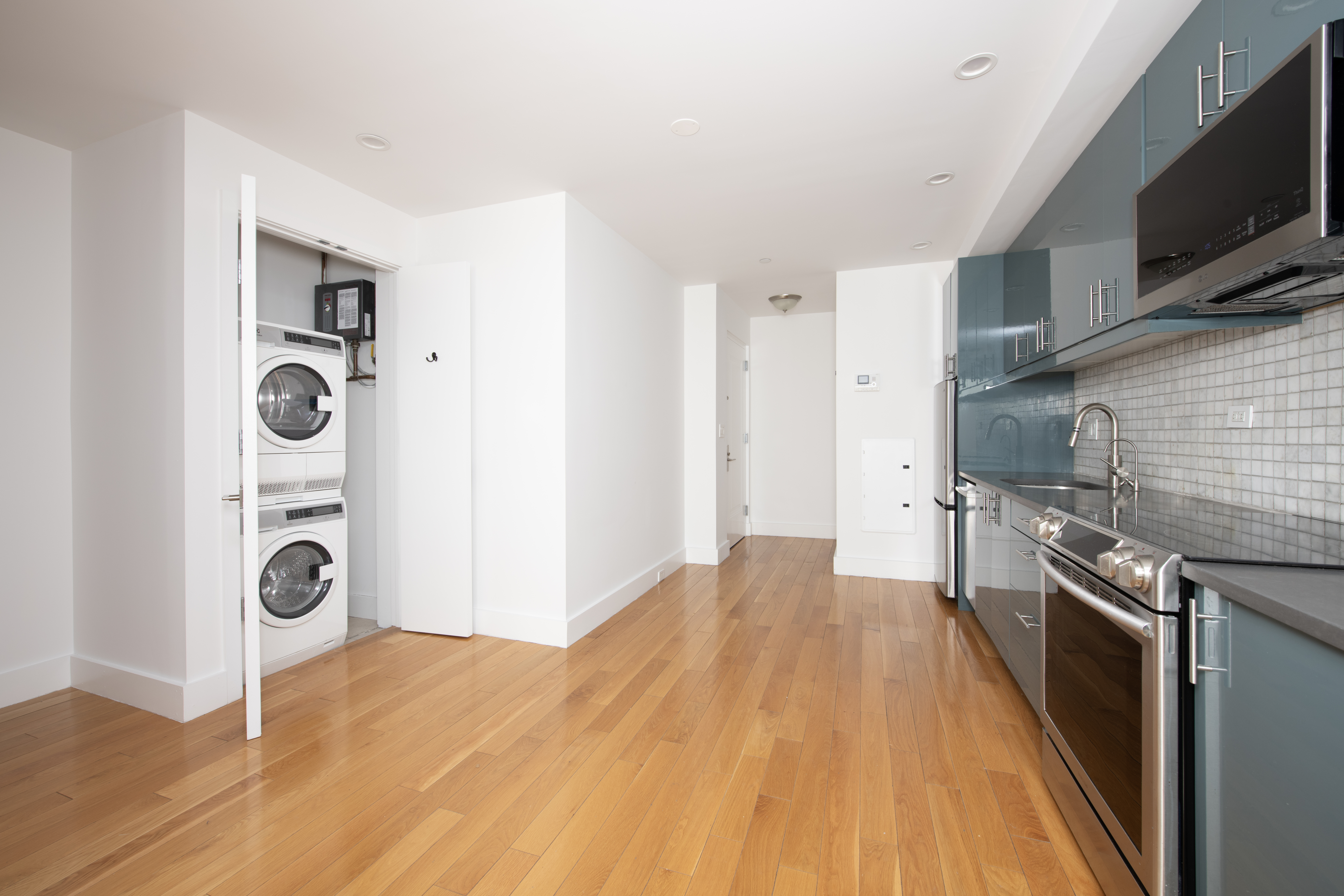 62 Box Street, Unit 6A Brooklyn, NY 11222 - Photo 3 of 5 a kitchen with stainless steel appliances granite countertop a stove and a refrigerator