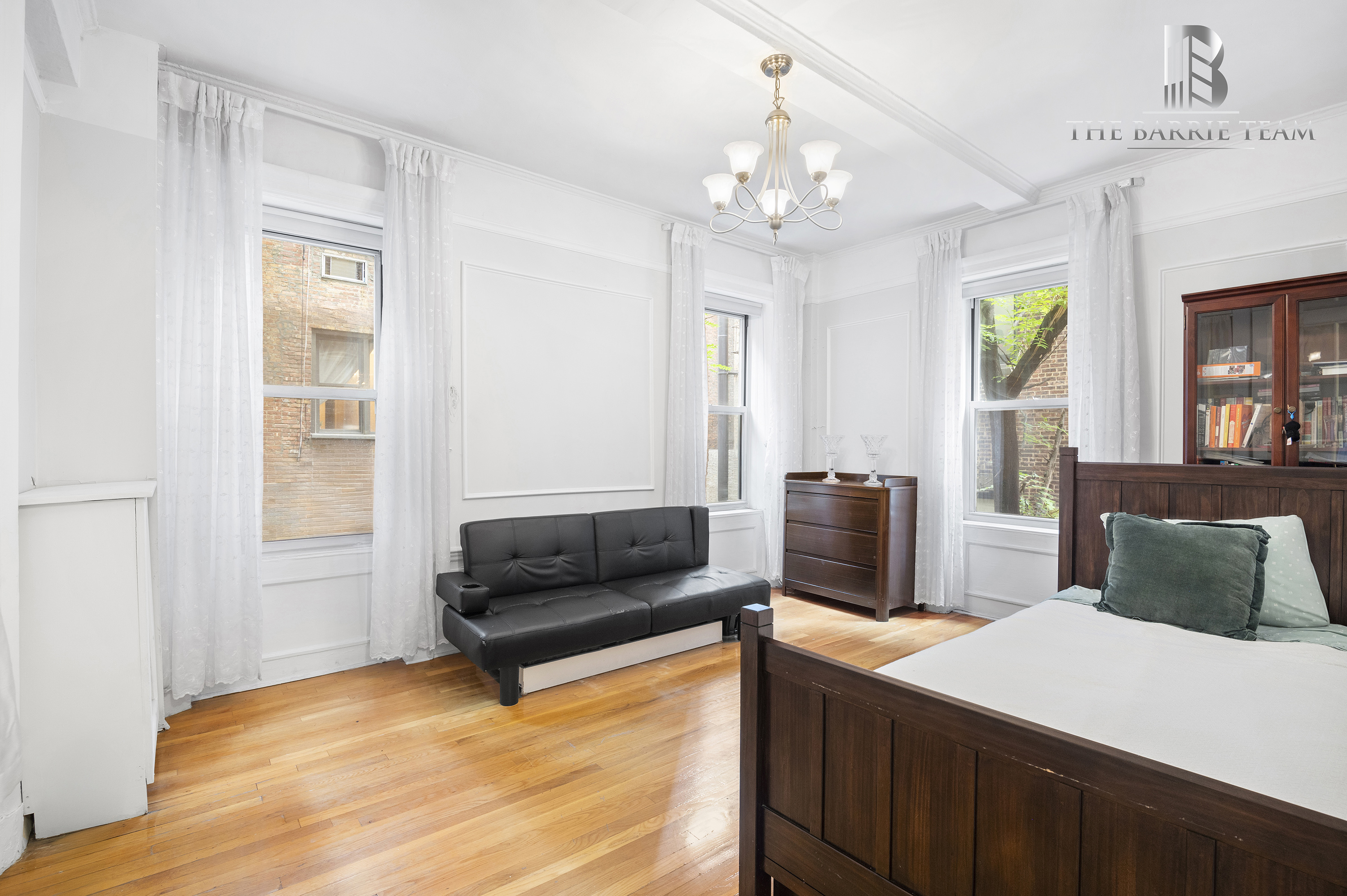 203 West 81st Street, Unit 3E Manhattan, NY 10024 - Photo 3 of 6 a bedroom with a bed windows and couch
