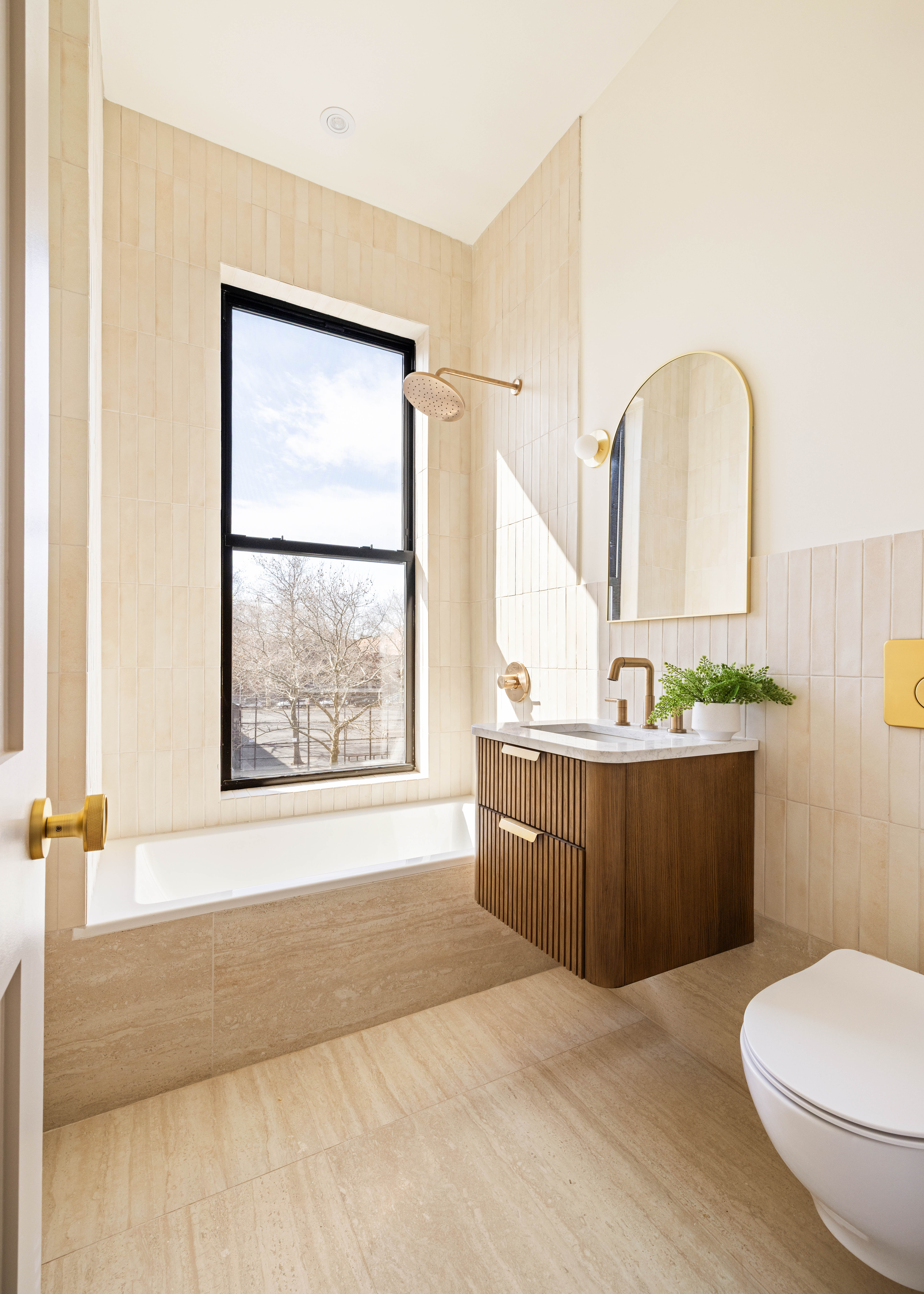 311 Monroe Street Brooklyn, NY 11216 - Photo 12 of 18 a bathroom with a granite countertop sink mirror vanity and a toilet