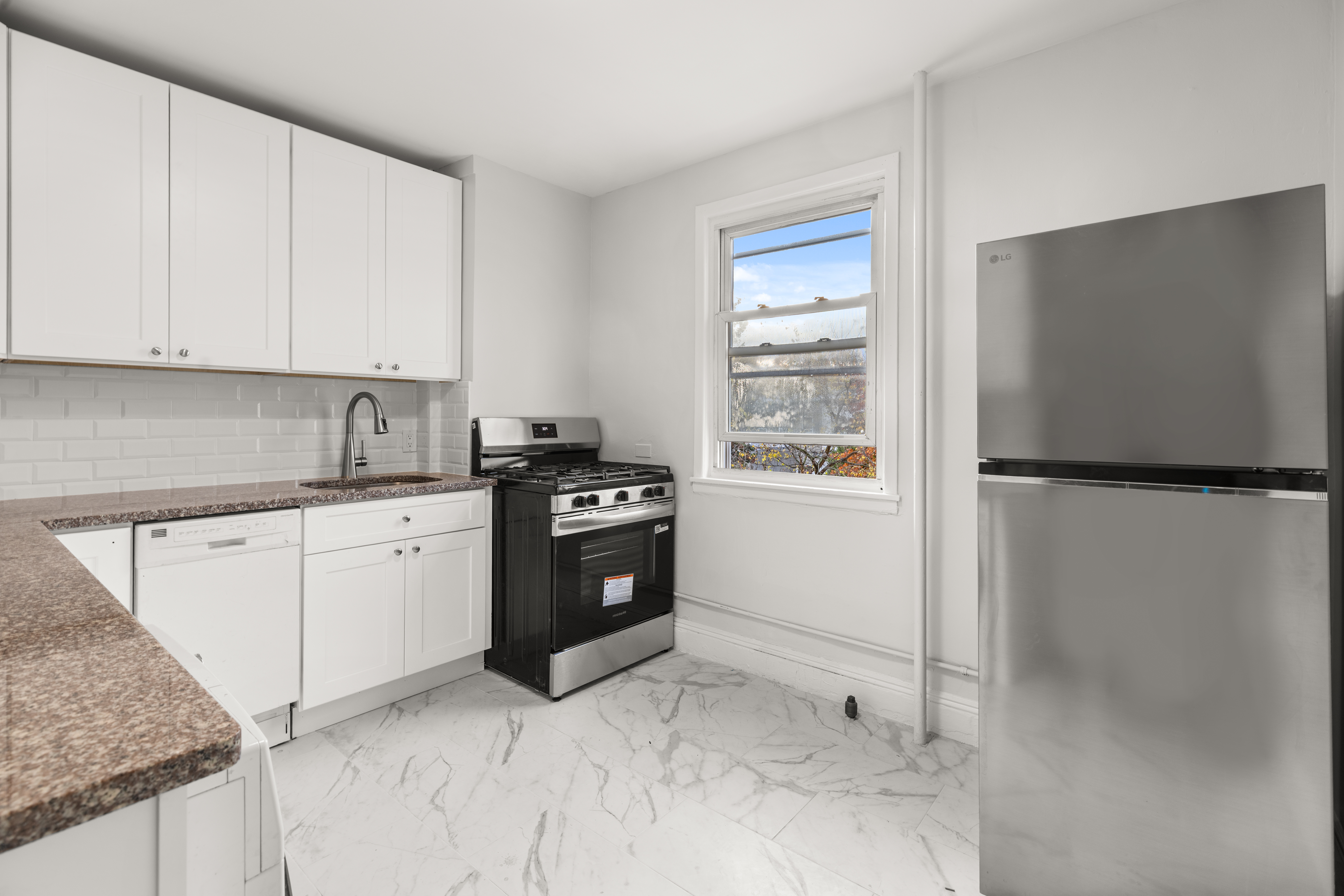 180 East 5th Street, Unit 2 Brooklyn, NY 11218 - Photo 5 of 14 a kitchen with a refrigerator stove and cabinets