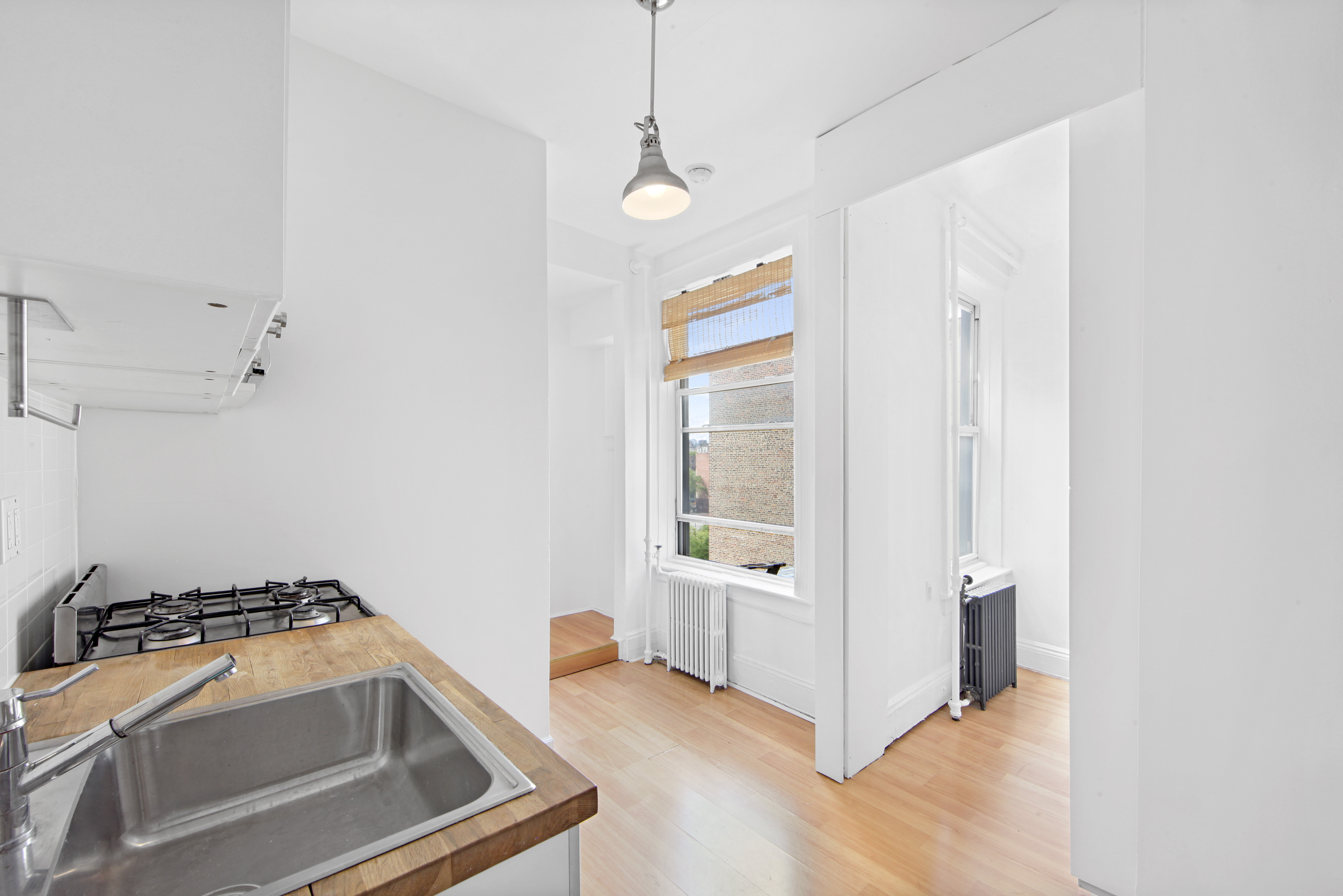 150 Sullivan Street, Unit 37 Manhattan, NY 10012 - Photo 2 of 12 a view of a storage and utility room with cabinet