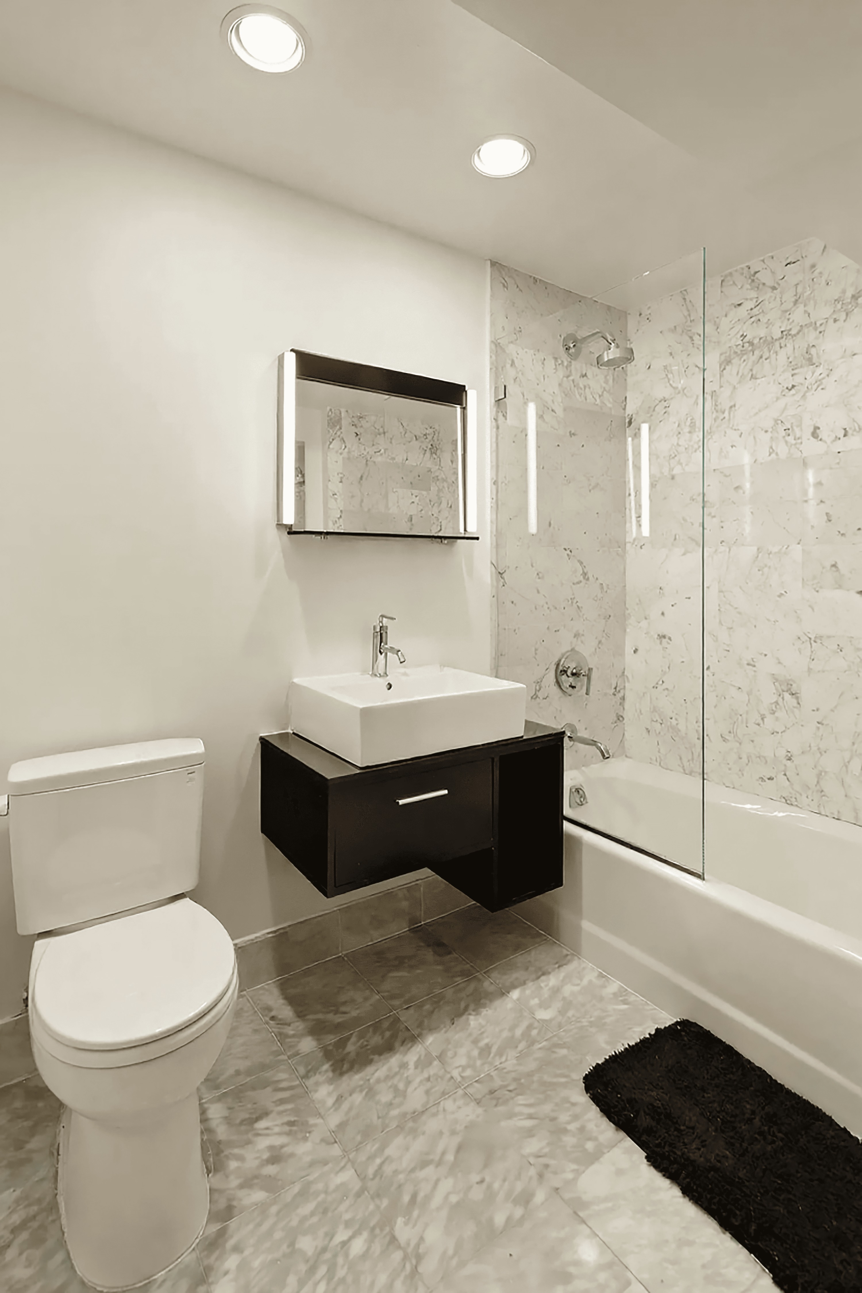 257 West 117th Street, Unit 2G Manhattan, NY 10026 - Photo 8 of 11 a bathroom with a bathtub shower sink mirror and toilet