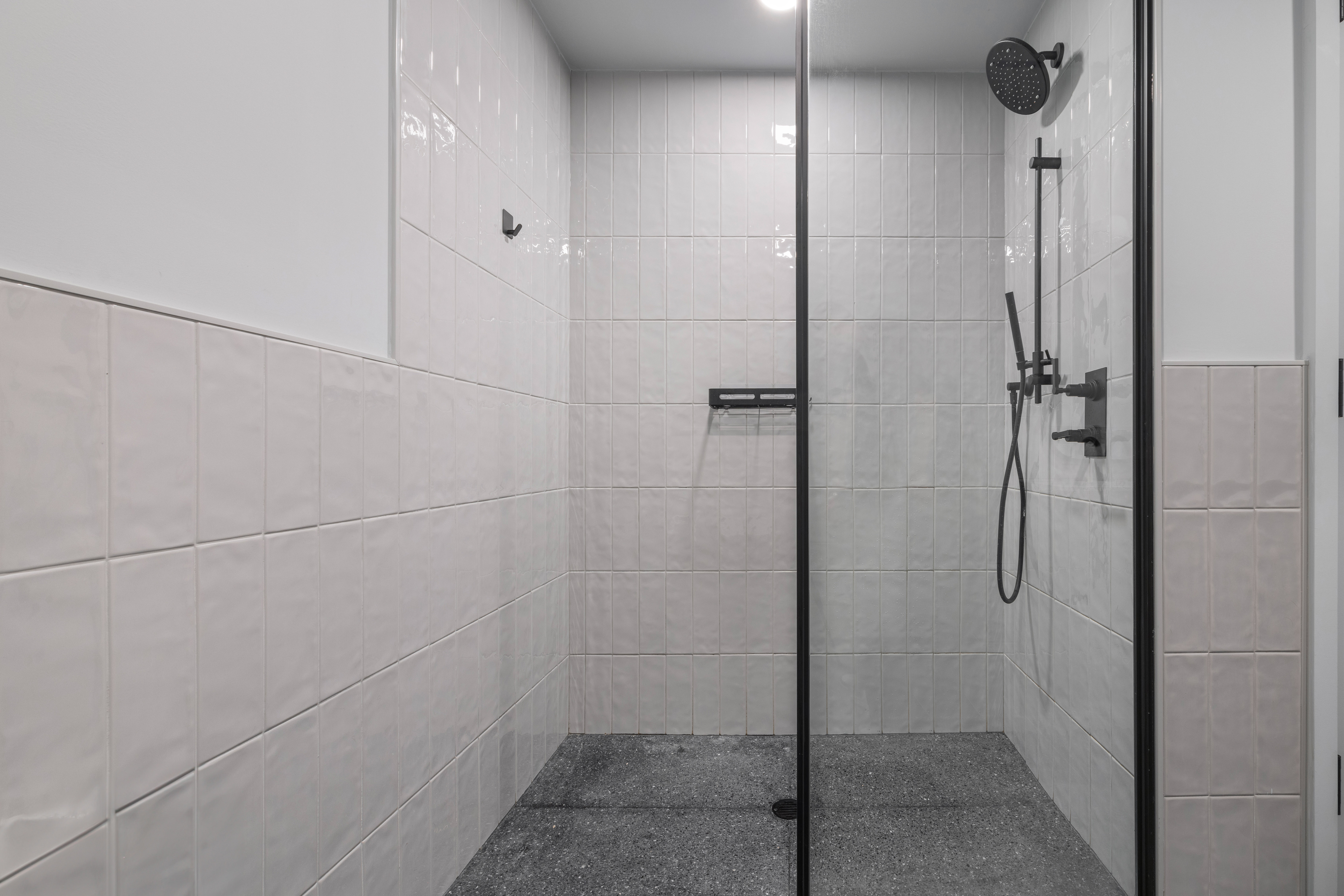 547 West 47th Street, Unit 509 Manhattan, NY 10036 - Photo 12 of 29 a bathroom with a glass shower door