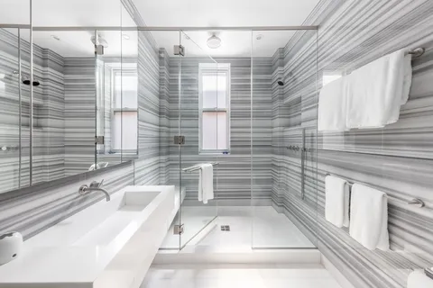 a bathroom with a tub shower and sink