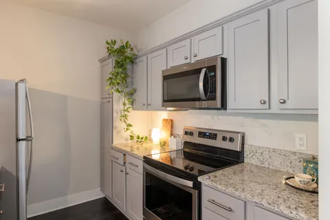 a kitchen with appliances a microwave and cabinets