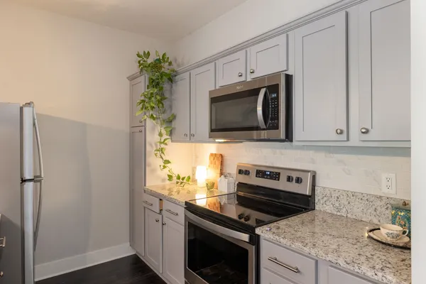a kitchen with appliances a microwave and cabinets