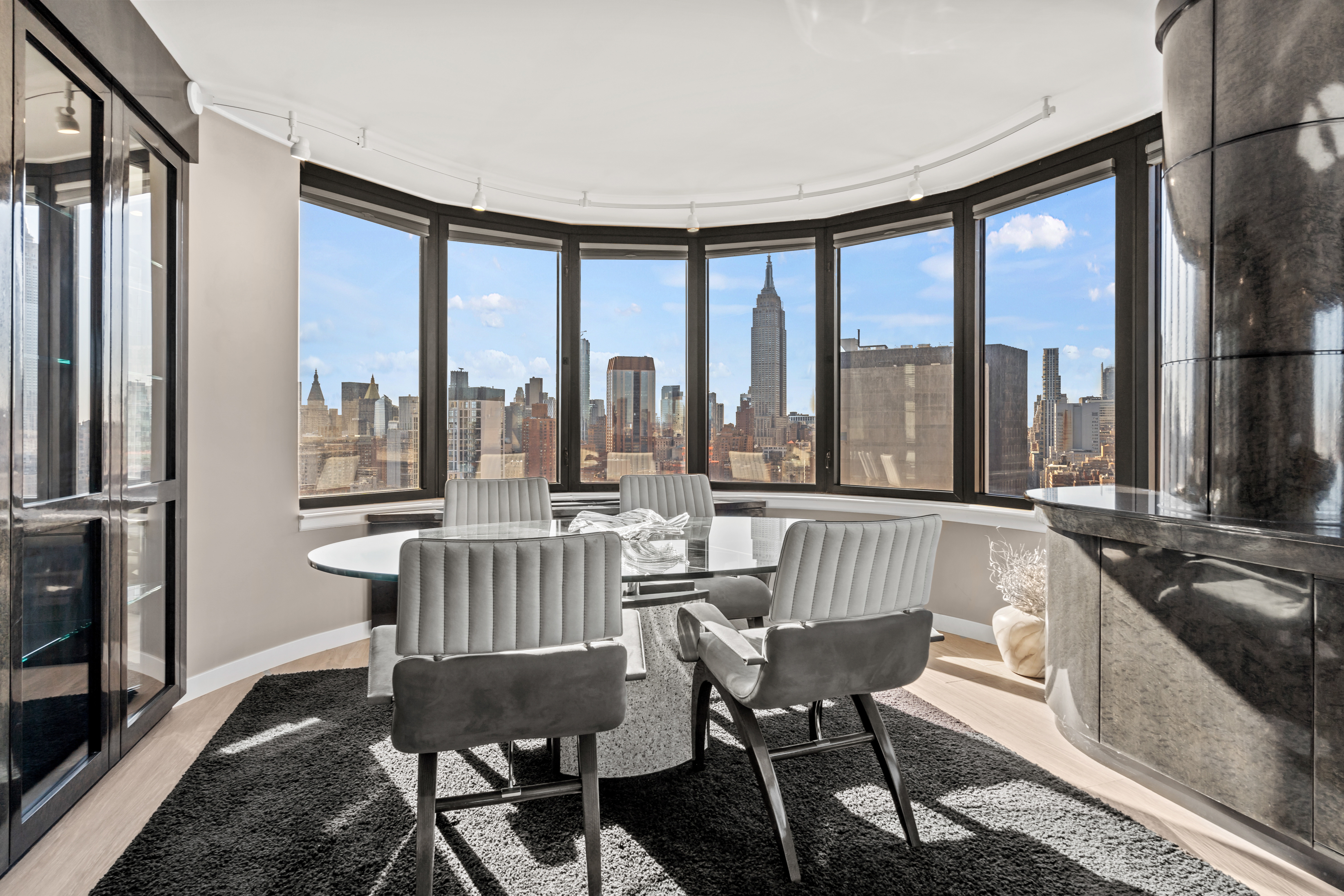 330 East 38th Street, Unit 38E Manhattan, NY 10016 - Photo 3 of 35 a view of a dining room with furniture a chandelier and wooden floor