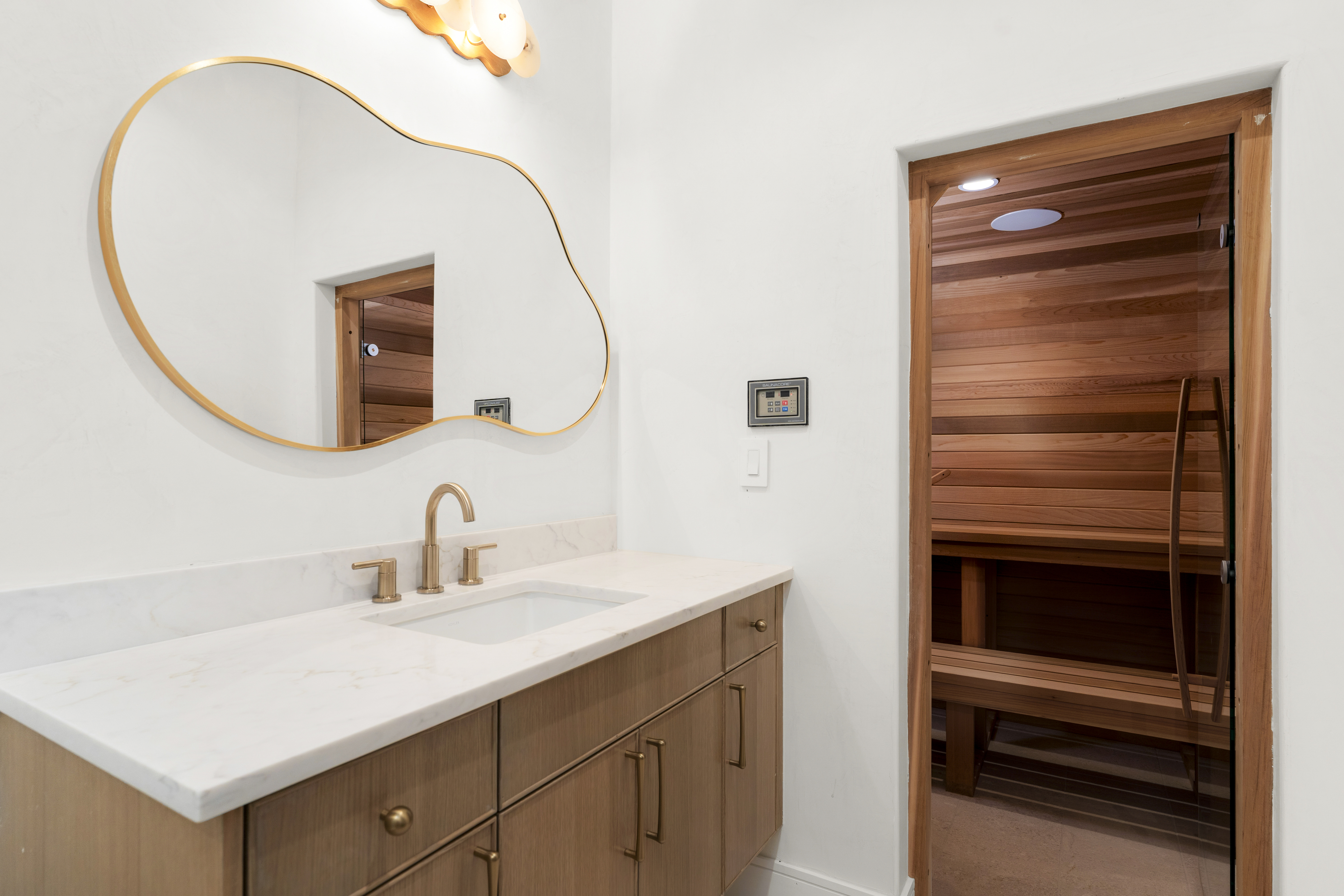 3411 Bridle Path Austin, TX 78703 - Photo 47 of 76 a bathroom with a sink a vanity and a mirror