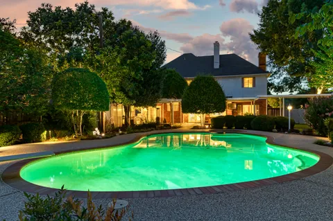 a view of a swimming pool with a patio