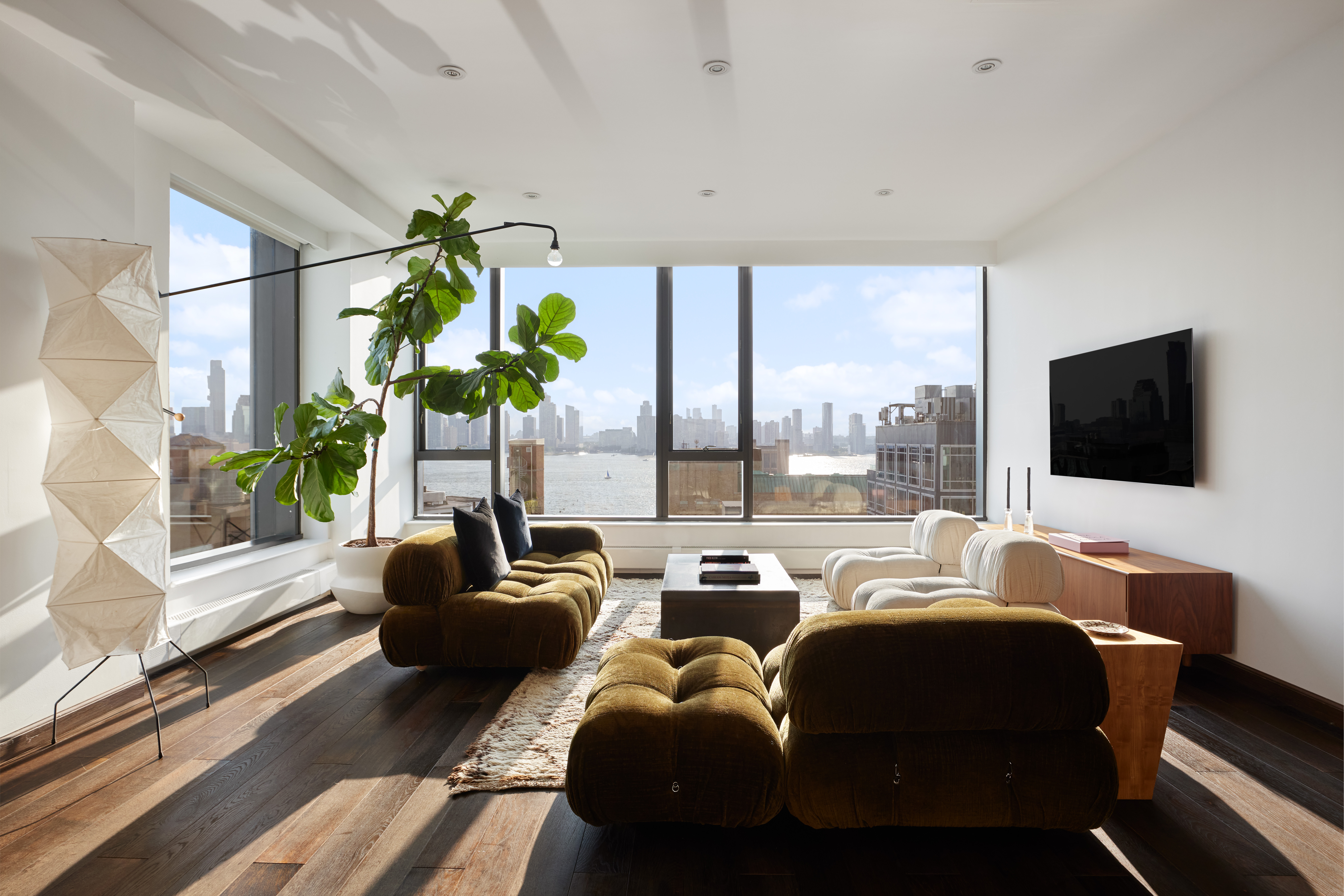 505 Greenwich Street, Unit 14A Manhattan, NY 10013 - Photo 2 of 20 a living room with furniture and a flat screen tv