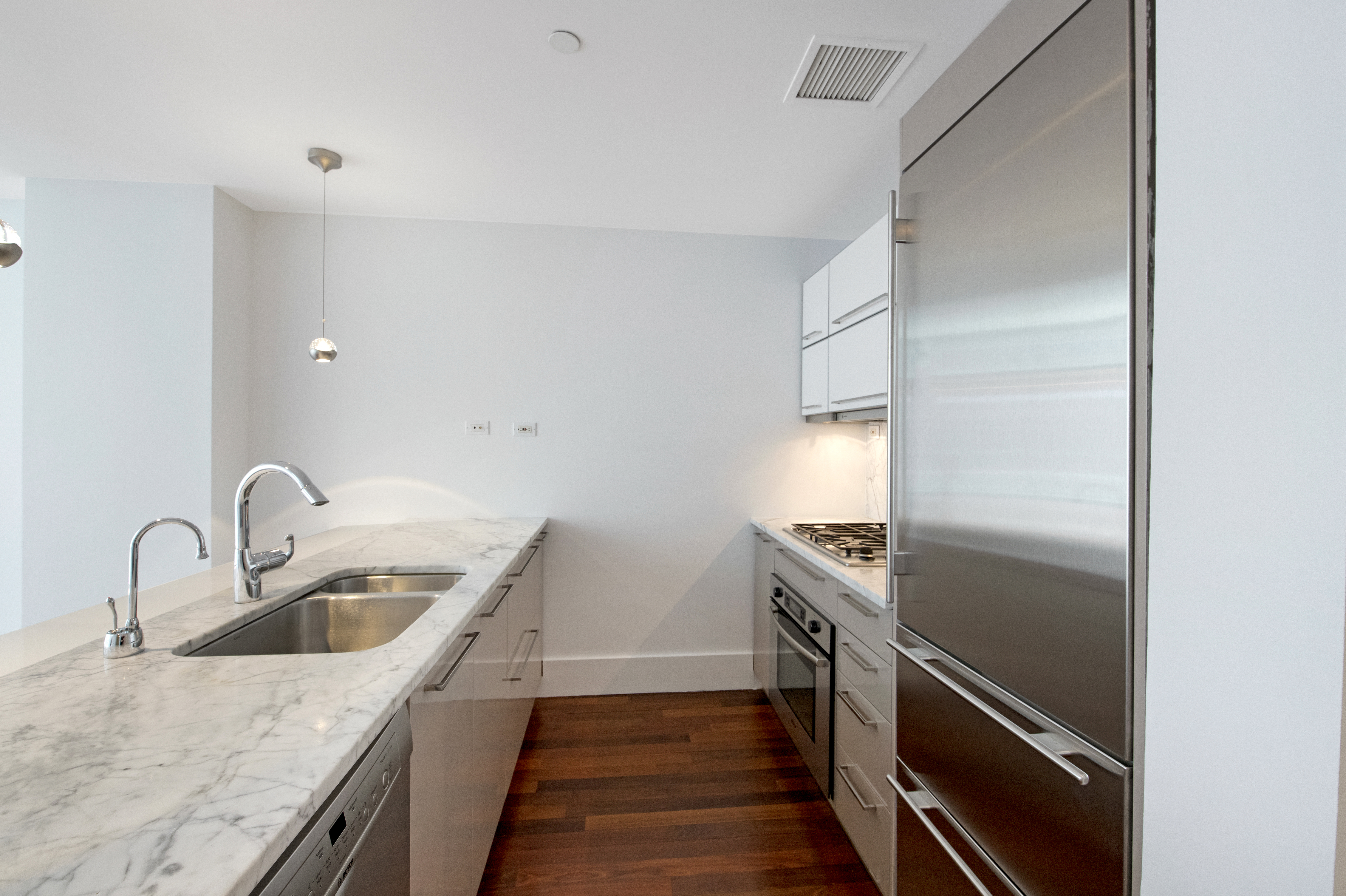 165 West 18th Street, Unit 8B Manhattan, NY 10011 - Photo 4 of 9 a kitchen with a refrigerator and a sink