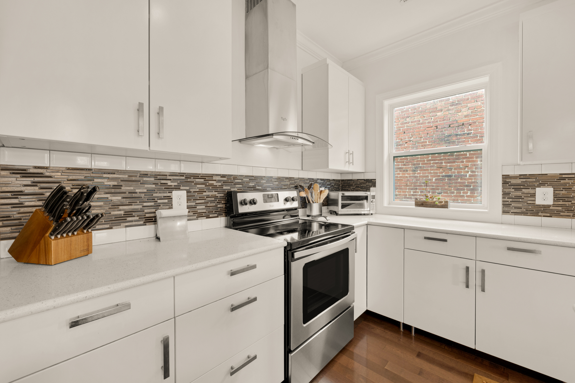 233 S Street Northeast, Unit 4 Washington, DC 20002 - Photo 16 of 37 a kitchen with white cabinets and white appliances
