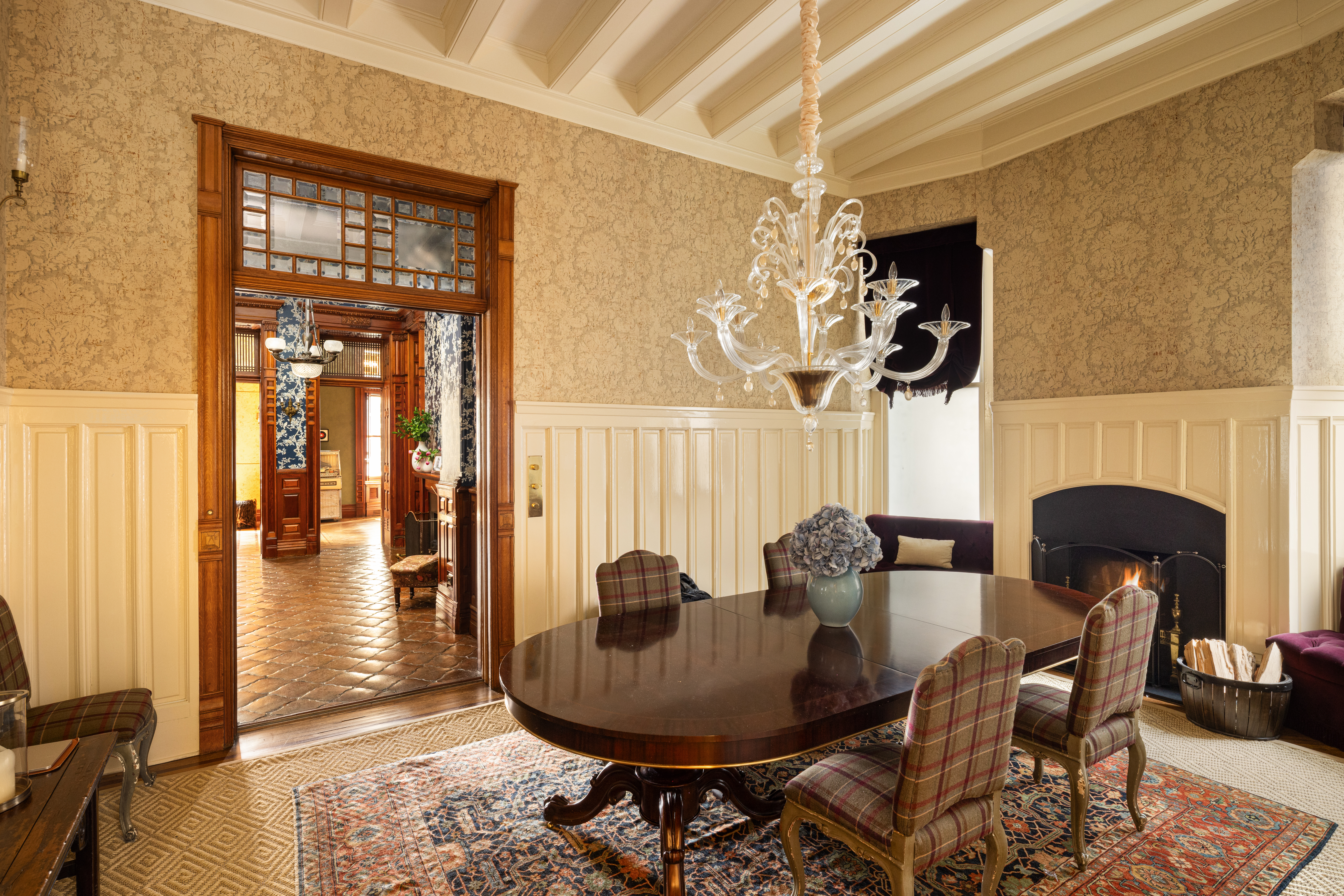 205 West 57th Street, Unit 4B Manhattan, NY 10019 - Photo 9 of 14 a dining room with furniture a fireplace and wooden floor