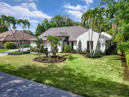 a view of a house with backyard garden and swimming pool