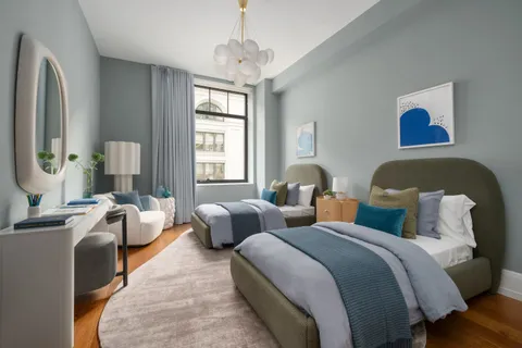 a bedroom with two beds and a couch