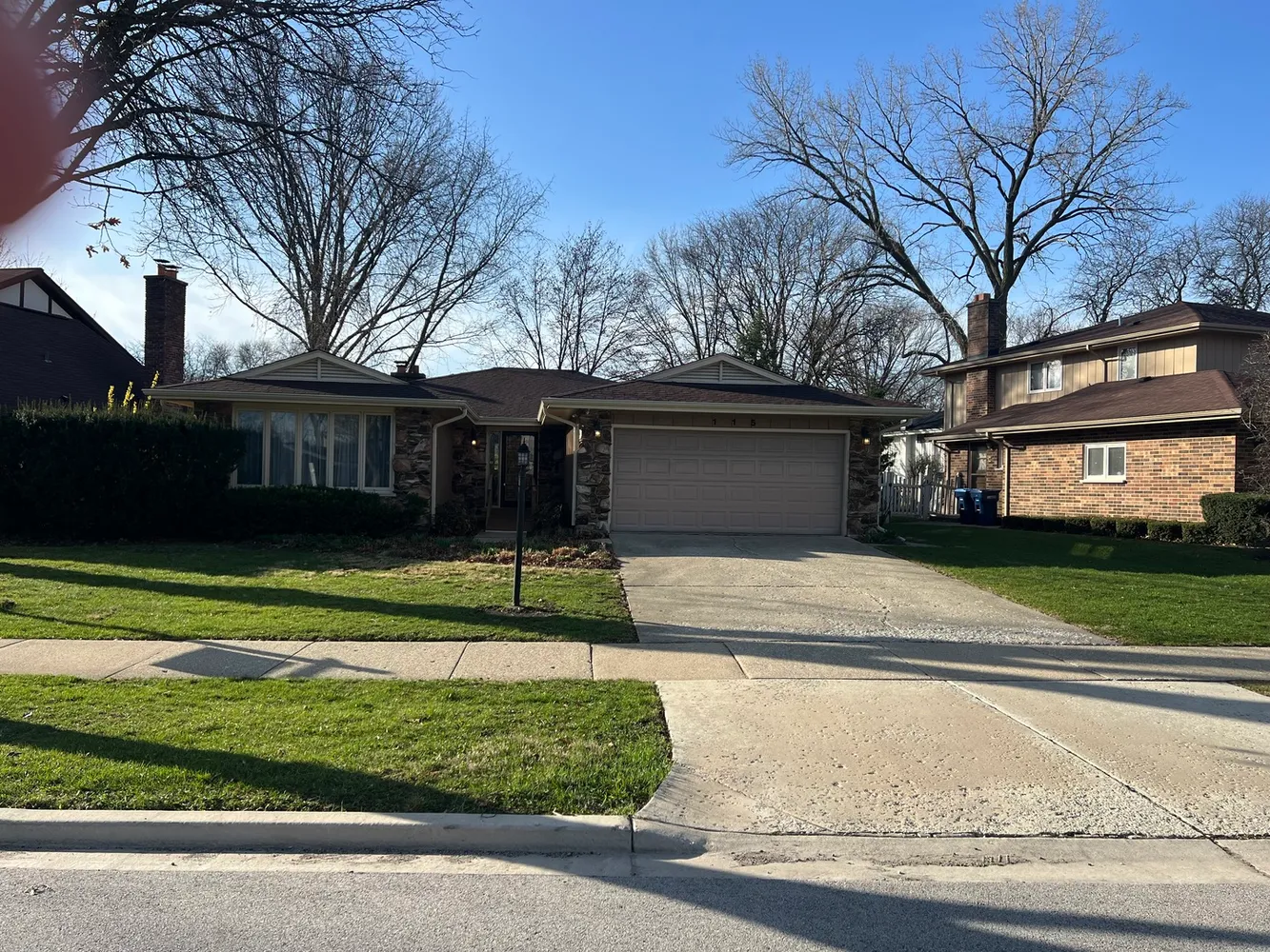 a view of a house with a yard and a large tree