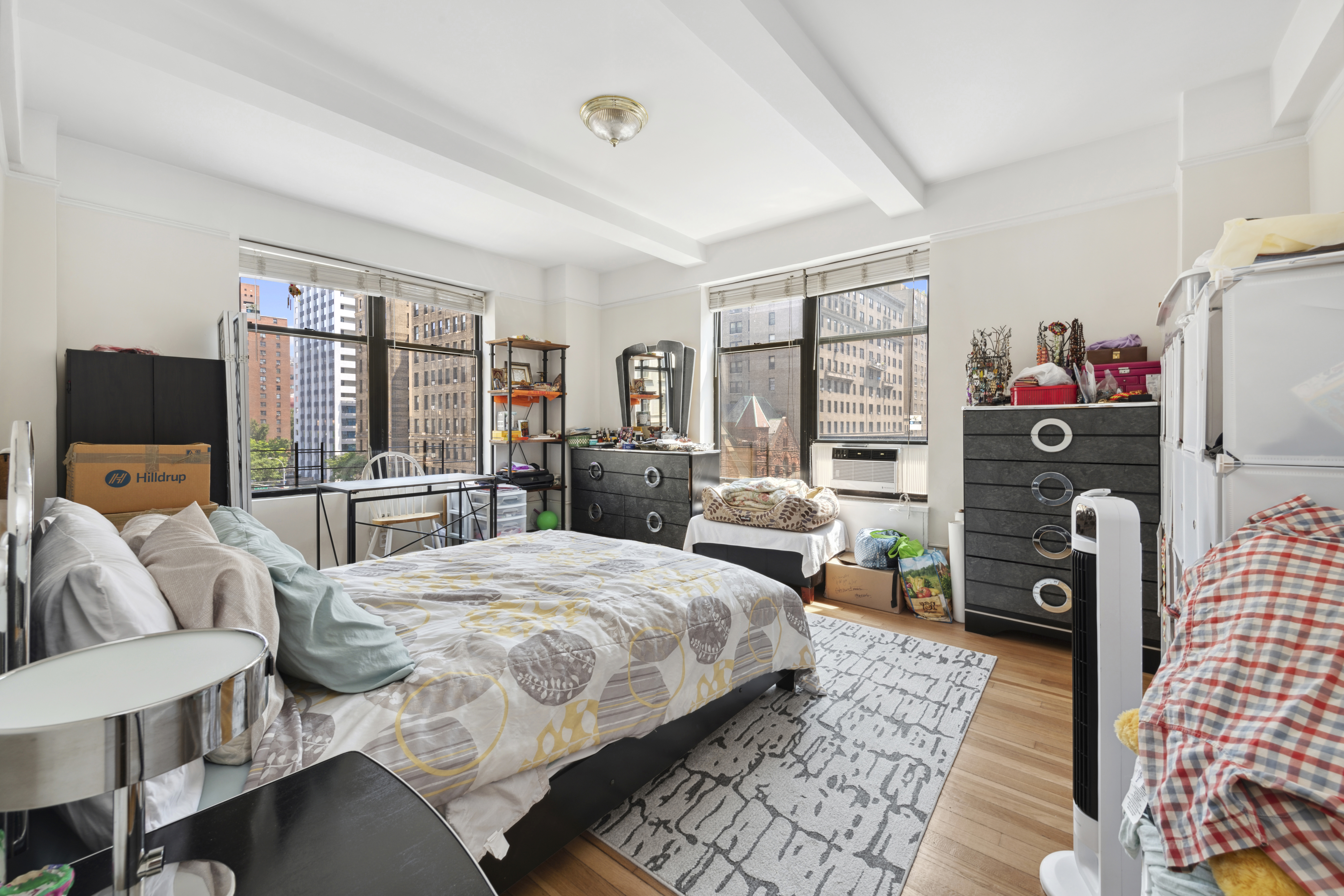 200 West 86th Street, Unit 7C Manhattan, NY 10024 - Photo 7 of 14 a bedroom with a bed a couch and large window
