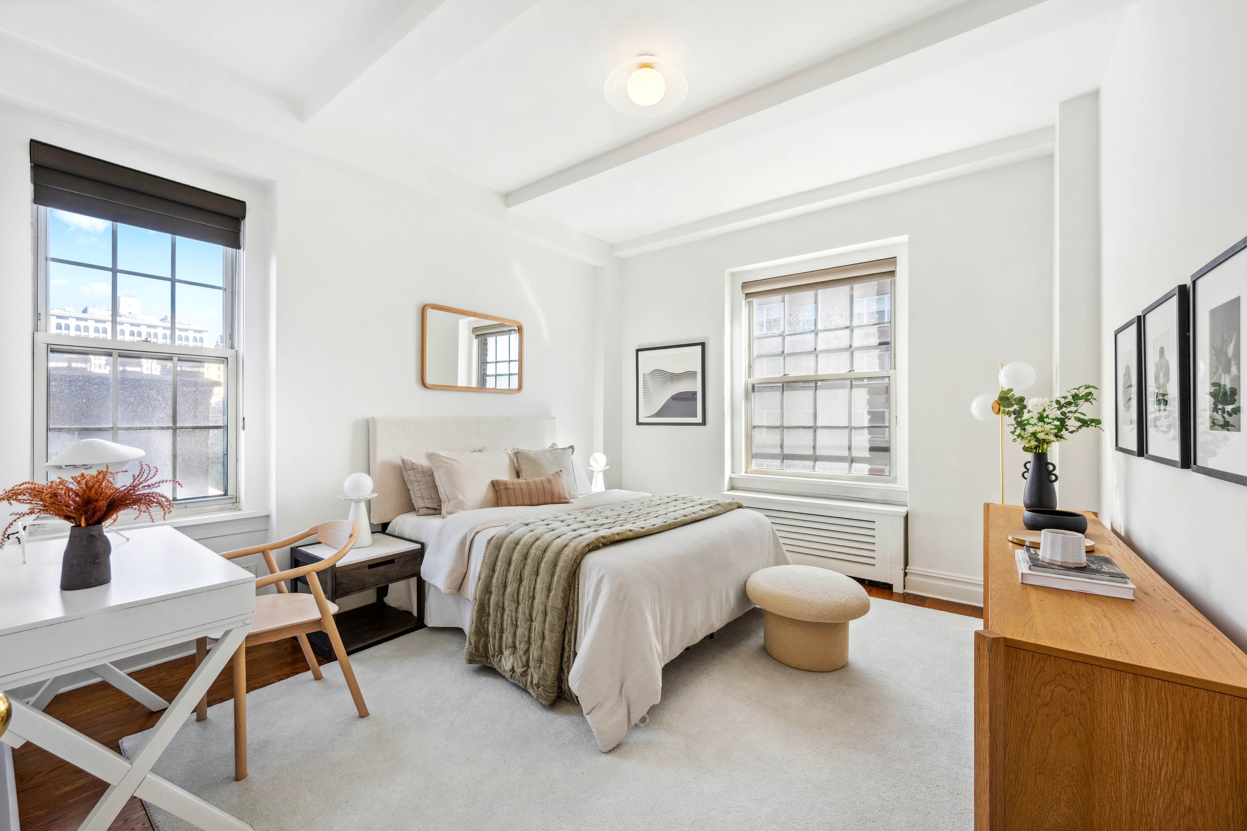 25 5th Avenue, Unit 6C Manhattan, NY 10003 - Photo 9 of 16 a spacious bedroom with a bed and a table