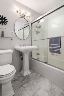 a bathroom with a sink toilet and shower