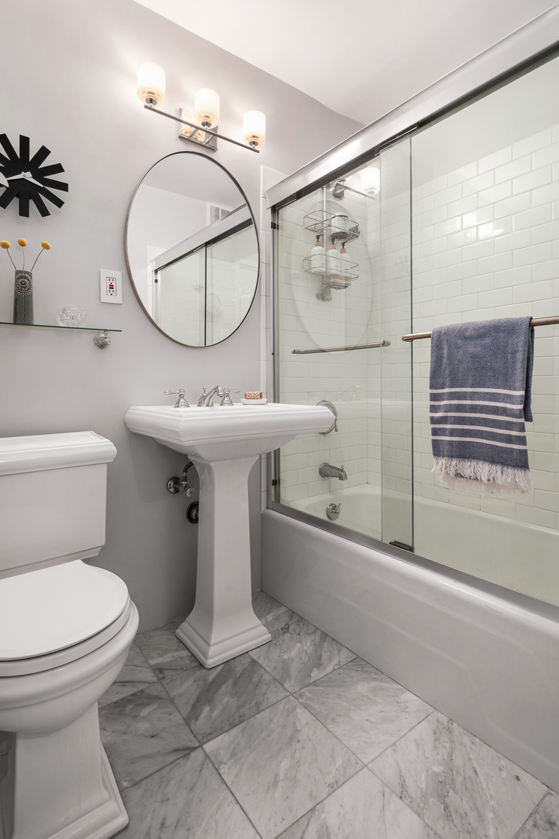 150 West End Avenue, Unit 24S Manhattan, NY 10023 - Photo 7 of 14 a bathroom with a sink toilet and shower