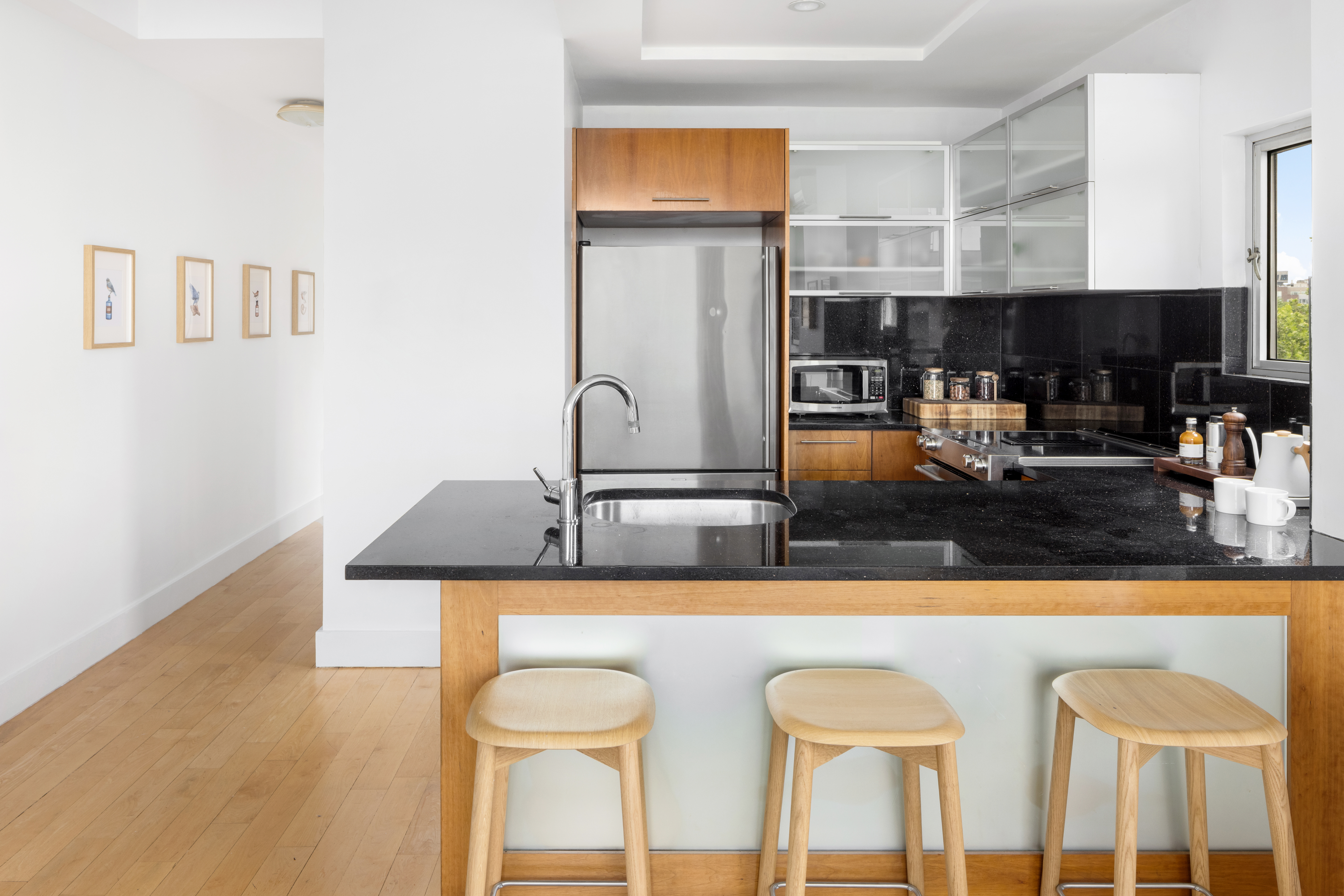297 Driggs Avenue, Unit 4A Brooklyn, NY 11222 - Photo 5 of 9 a kitchen with a sink a stove and a refrigerator