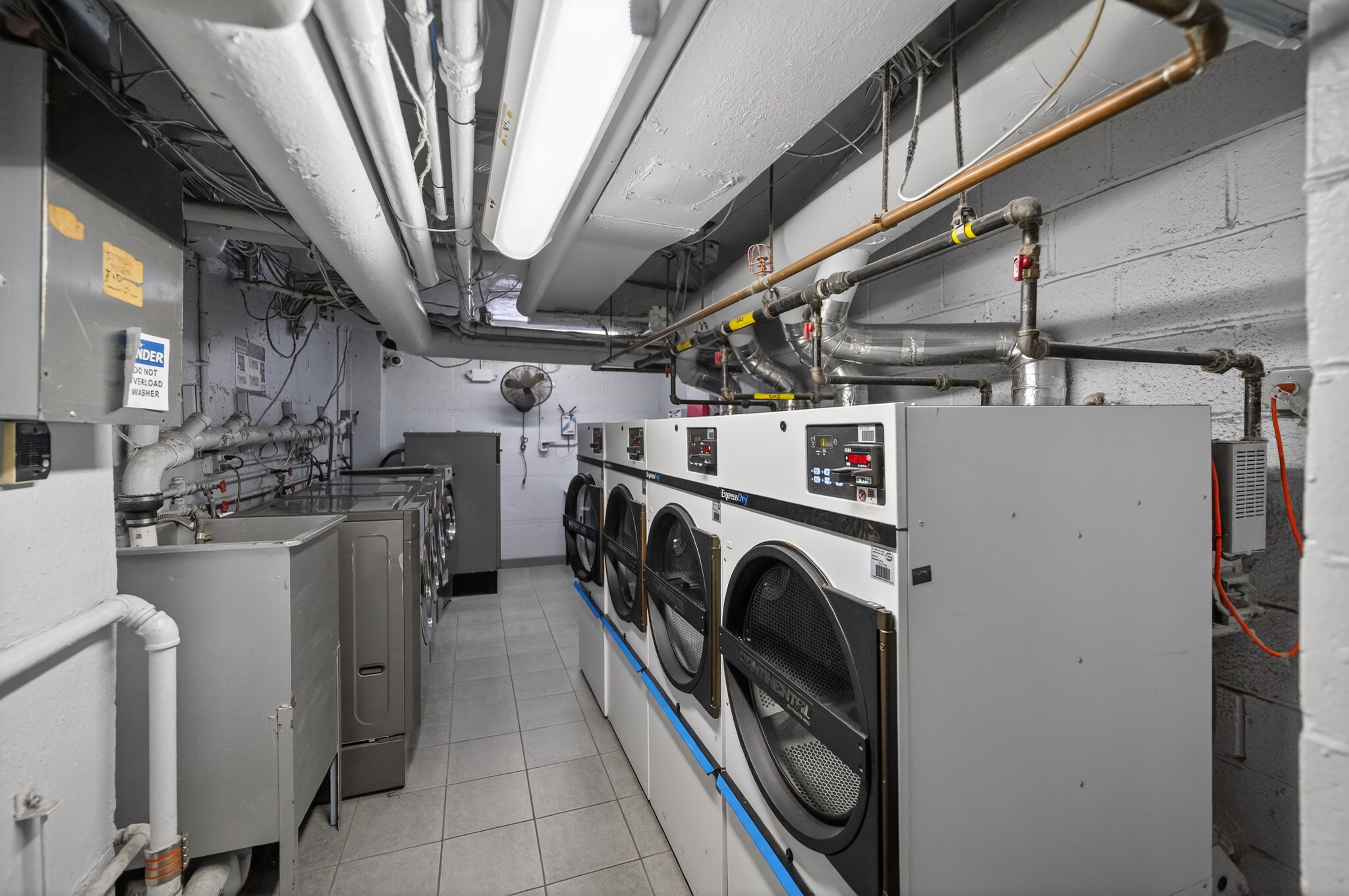 233 East 69th Street, Unit 16F Manhattan, NY 10021 - Photo 10 of 11 a utility room with dryer and washer