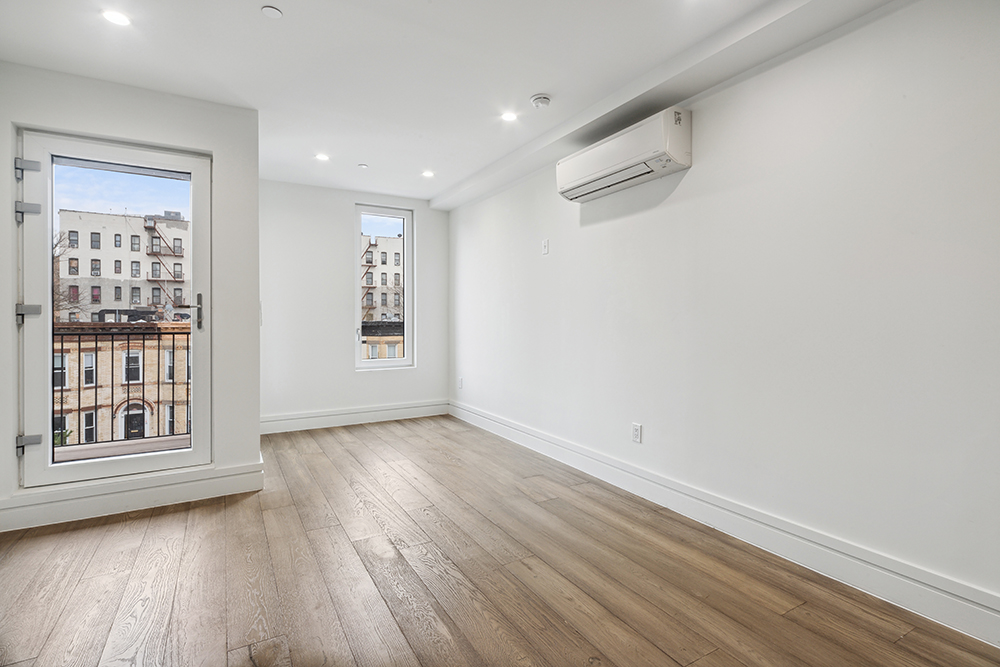 143 Winthrop Street, Unit 3C Brooklyn, NY 11225 - Photo 3 of 9 a view of an empty room with wooden floor and a window