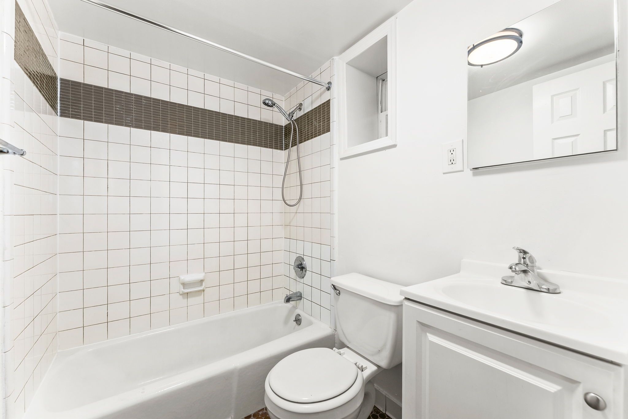 333 East 92nd Street, Unit 4A Manhattan, NY 10128 - Photo 4 of 5 a bathroom with a sink toilet and shower