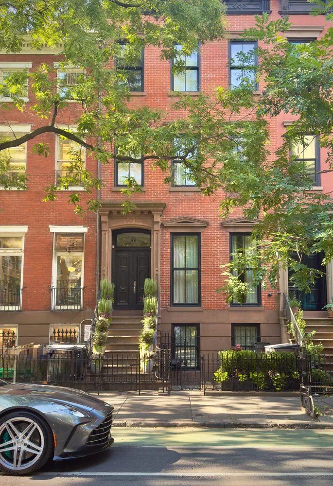 a front view of a residential apartment building with a yard