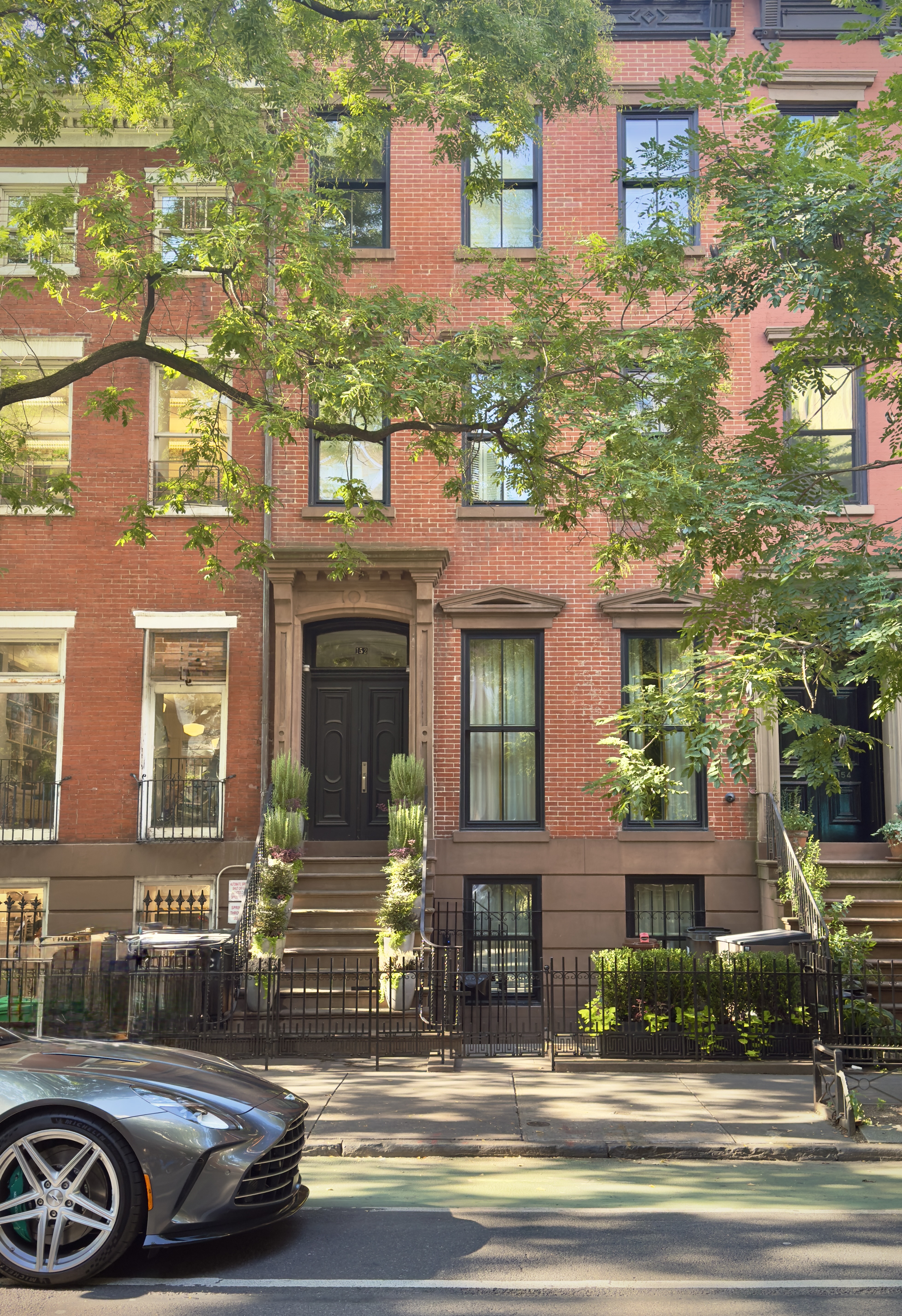 152 West 13th Street Manhattan, NY 10011 - Photo 27 of 28 a front view of a residential apartment building with a yard