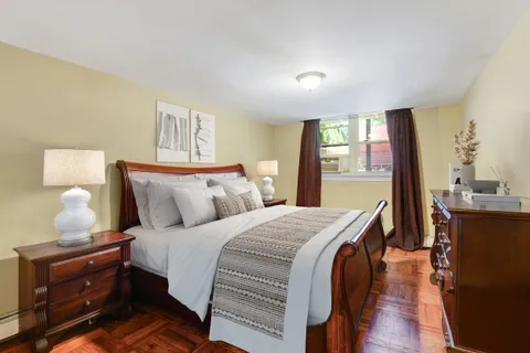 a bedroom with bed and window