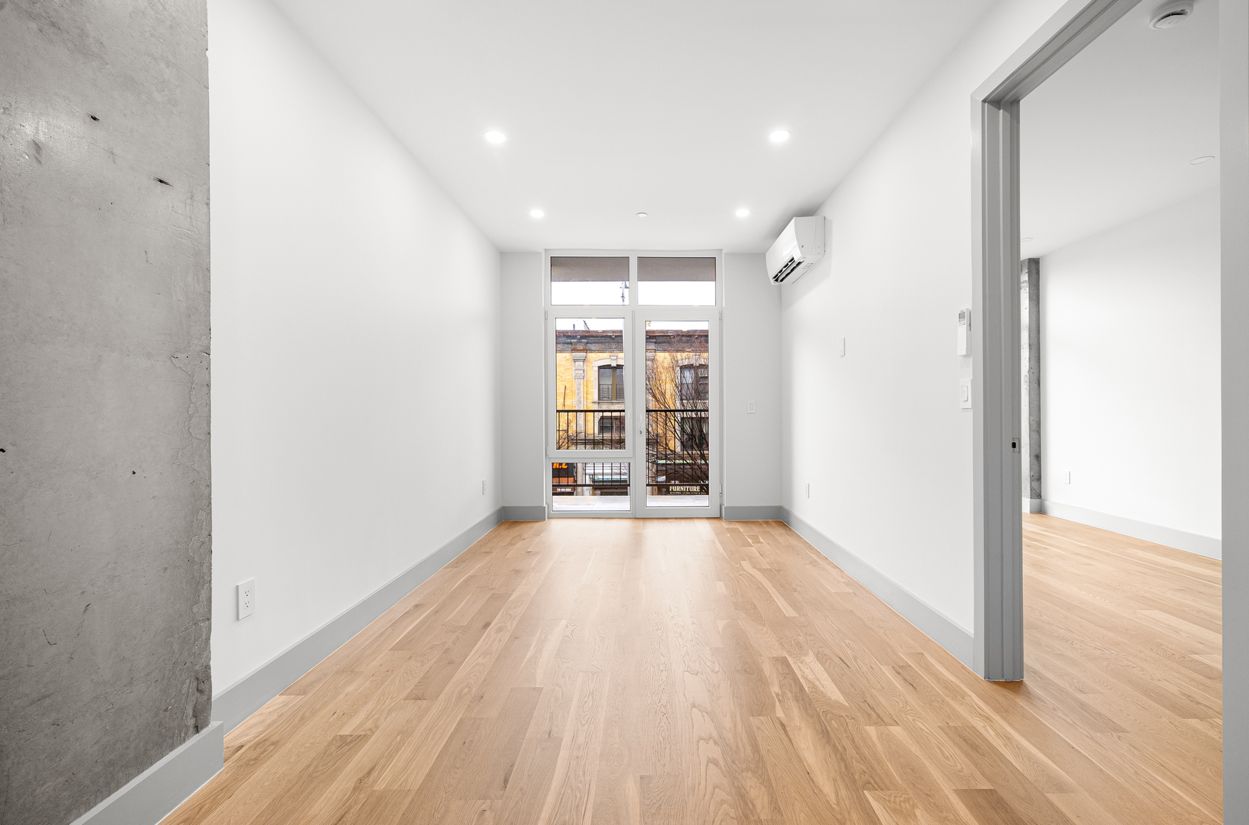 1155 Bedford Avenue, Unit 3F Brooklyn, NY 11216 - Photo 9 of 12 a view of an empty room with wooden floor and a window