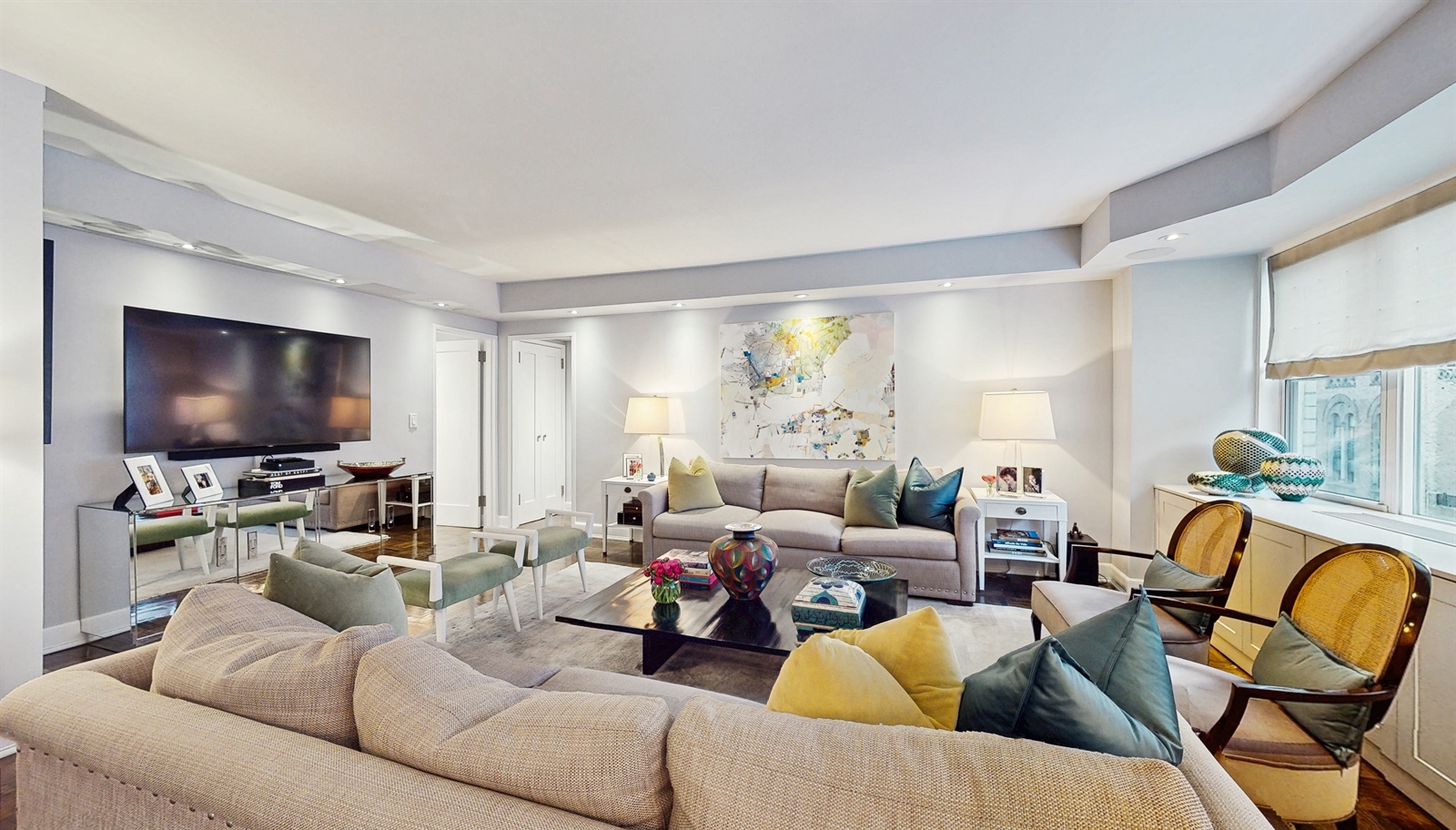 136 East 56th Street, Unit 16B Manhattan, NY 10022 - Photo 1 of 11 a living room with furniture and a flat screen tv
