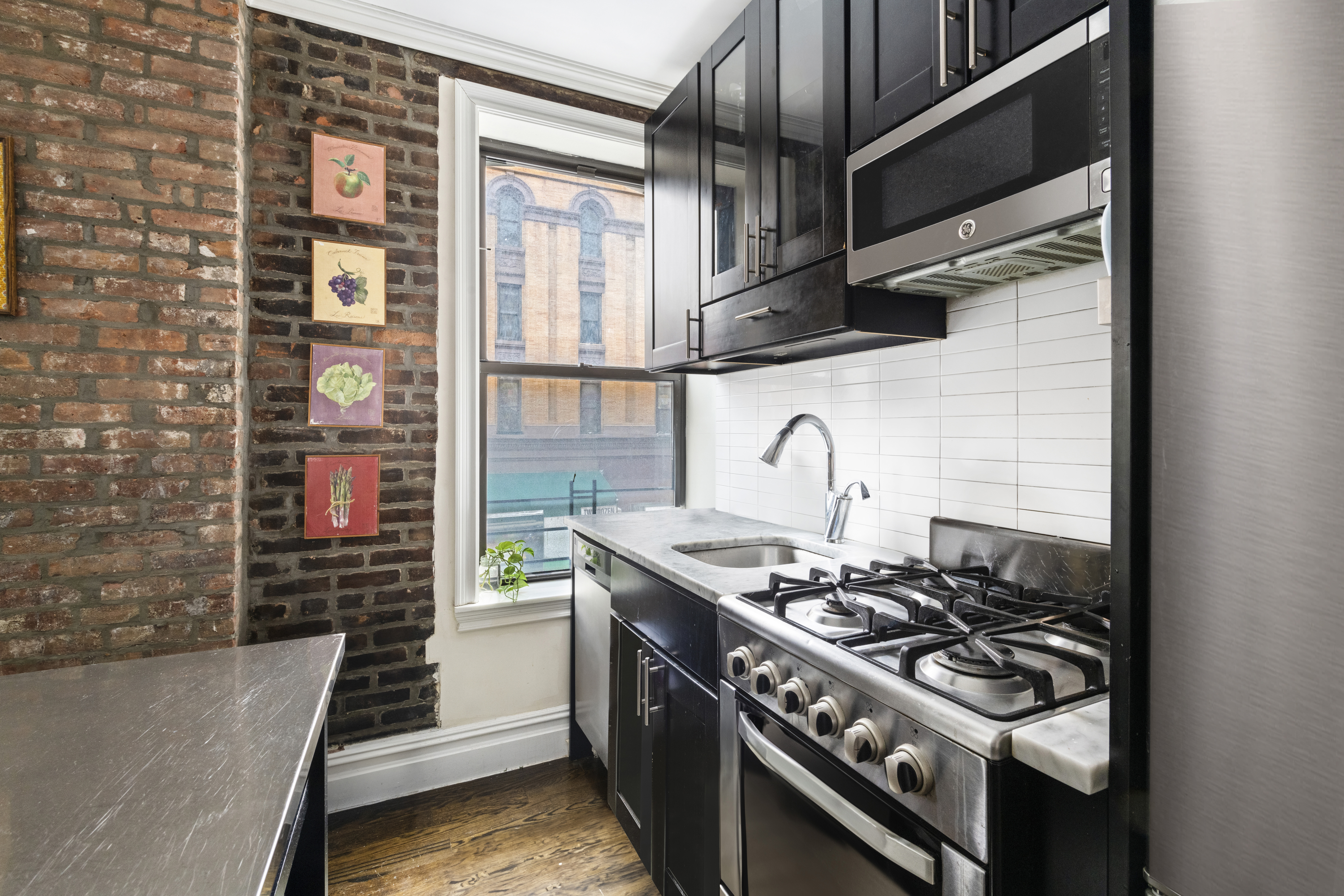 170 West 83rd Street, Unit 2W Manhattan, NY 10024 - Photo 3 of 10 a white stove top oven sitting inside of a kitchen