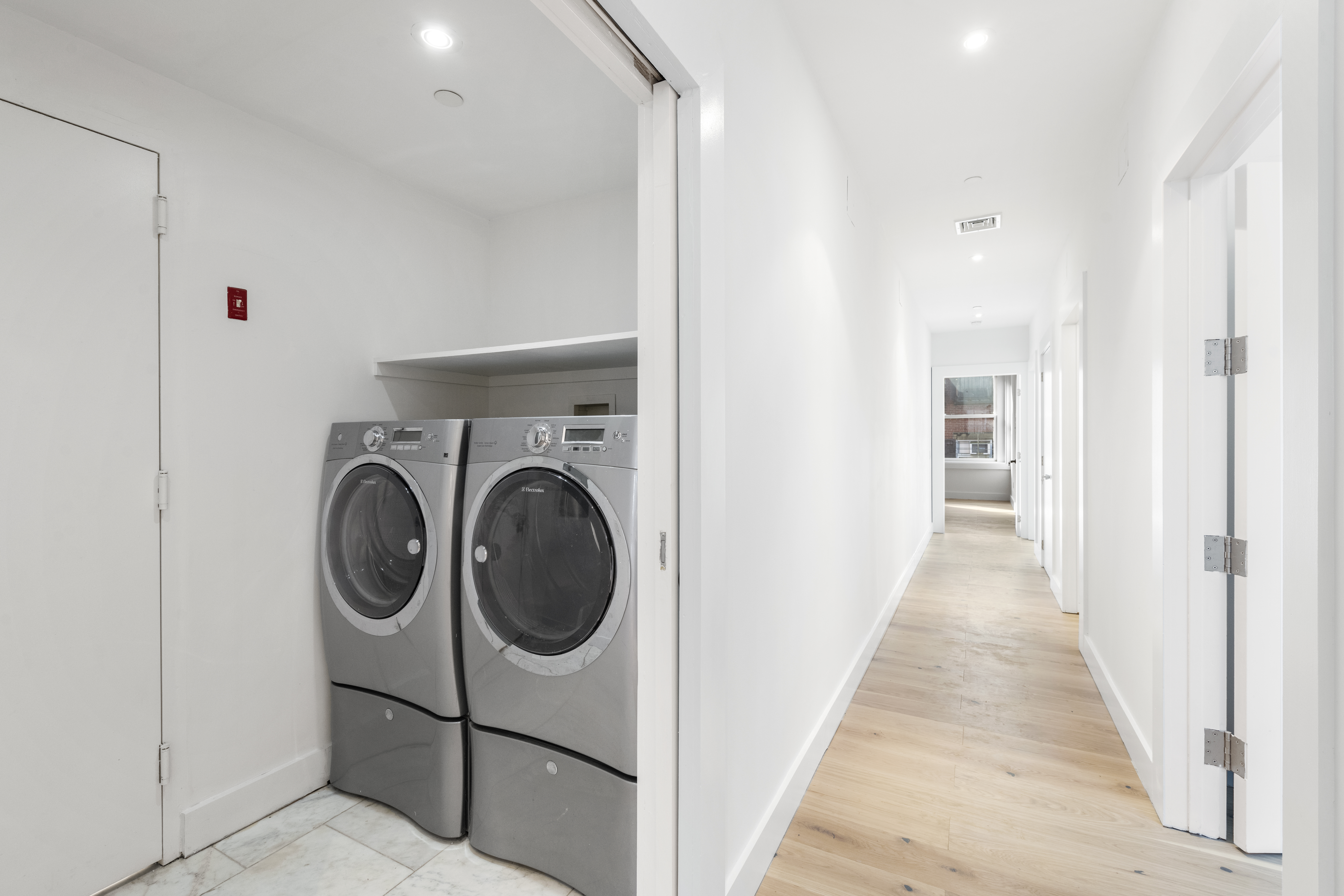 49 Walker Street, Unit PH Manhattan, NY 10013 - Photo 12 of 14 a view of a hallway with washer and dryer