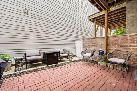 a balcony with furniture and a fireplace