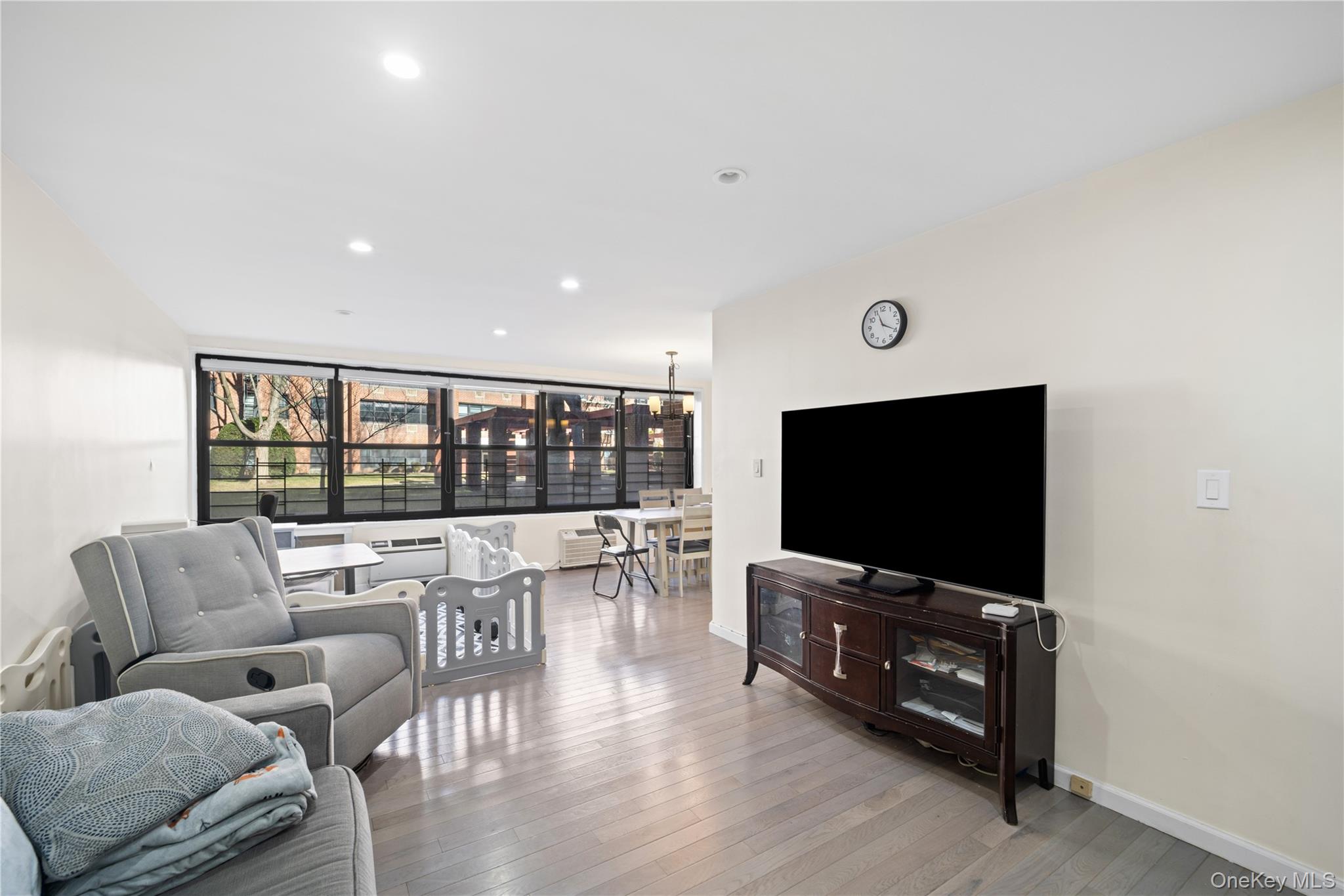 75-34 Bell Boulevard, Unit LD Queens, NY 11364 - Photo 7 of 26 a living room with furniture and a flat screen tv