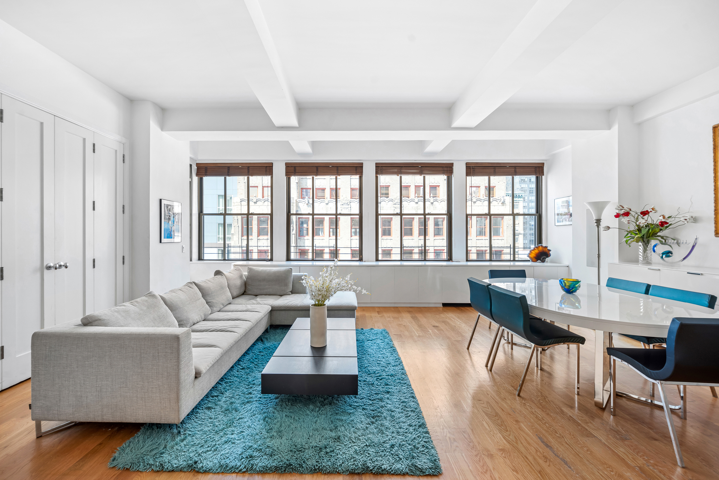 130 West 30th Street, Unit 16A Manhattan, NY 10001 - Photo 2 of 17 a living room with furniture and a large window