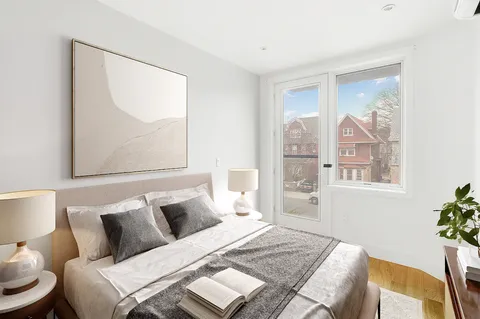 a bed room with a bed and a painting on the wall