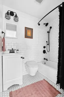 a bathroom with a toilet sink and shower
