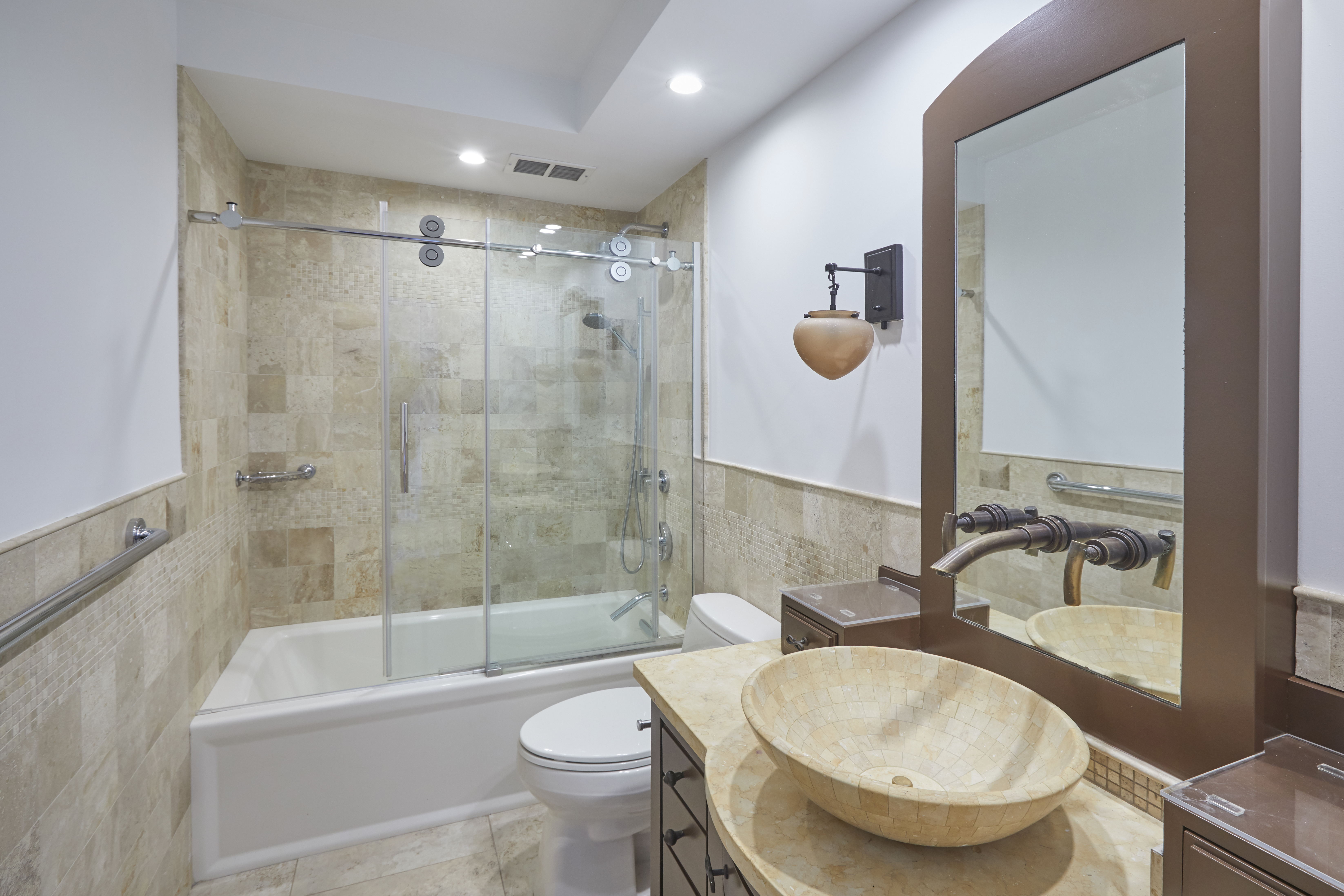 309 East 49th Street, Unit 3D Manhattan, NY 10017 - Photo 7 of 11 a bathroom with a granite countertop sink toilet mirror and bathtub
