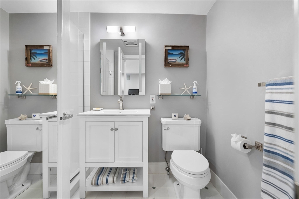135 West Concord Street, Unit 1 Boston, MA 02118 - Photo 28 of 36 a bathroom with a toilet a sink and mirror