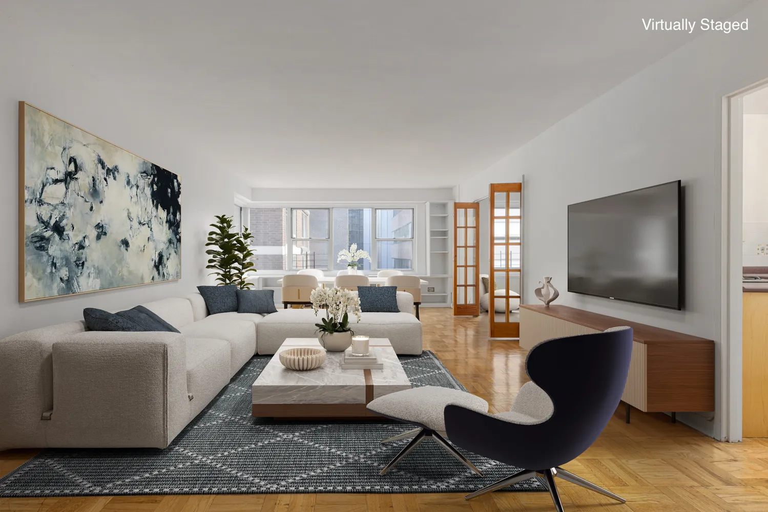a living room with furniture a rug and a flat screen tv