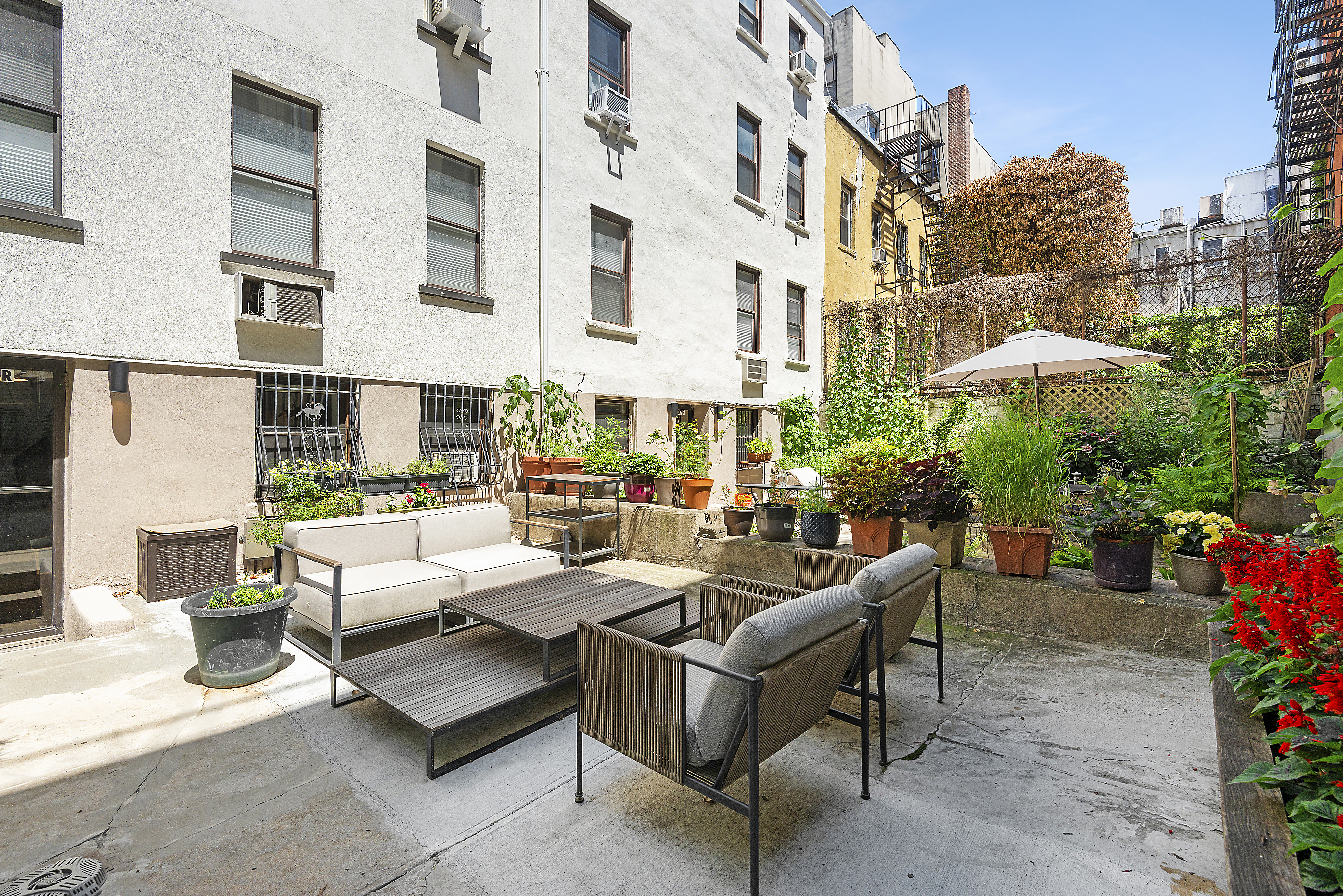 309 West 20th Street, Unit 1R Manhattan, NY 10011 - Photo 8 of 10 a view of a patio with couches table and chairs and potted plants