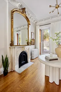 a view of a livingroom with furniture window wooden floor and a fireplace